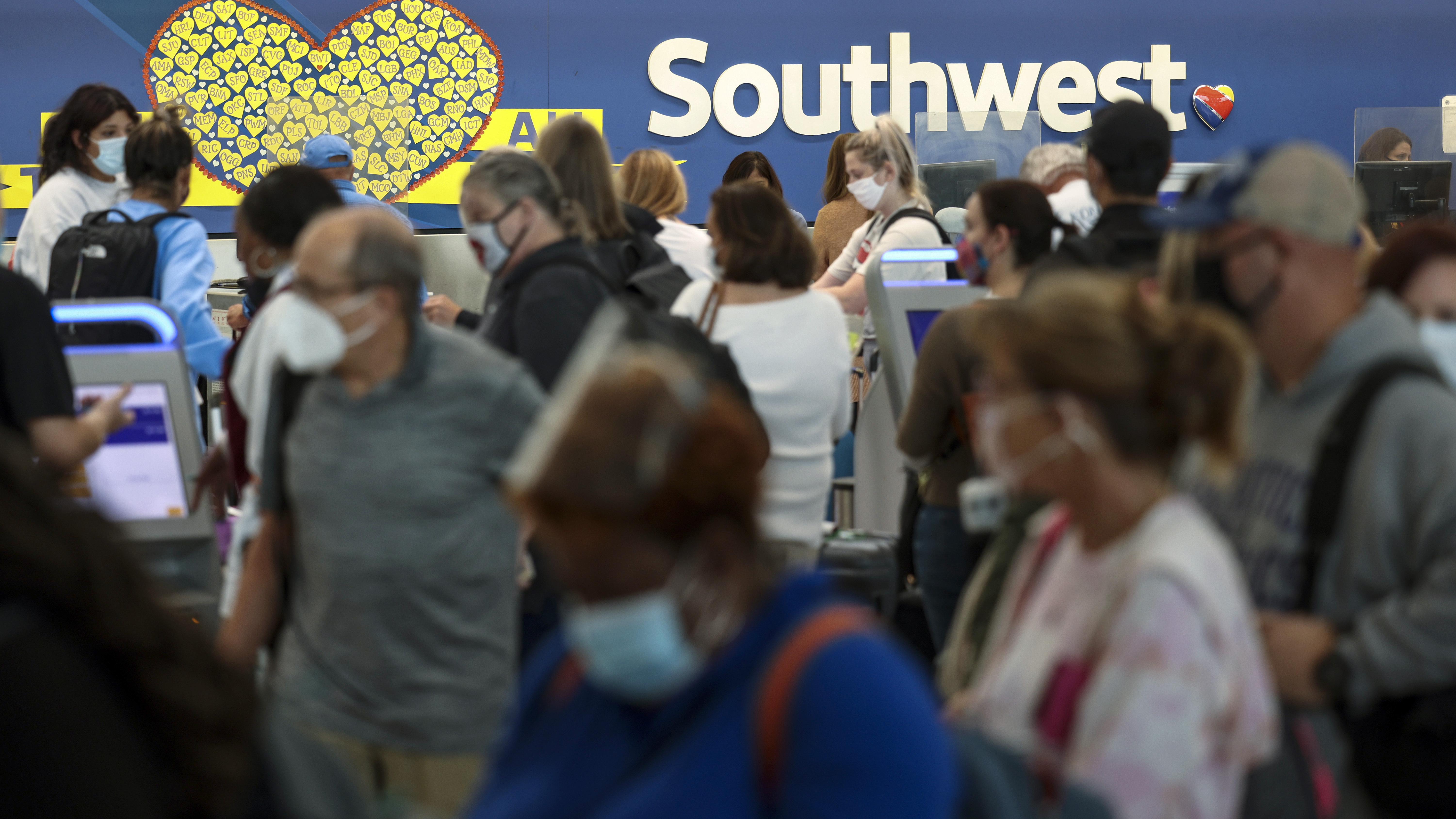 Southwest Airlines canceled at least 70% of its flights on Monday. In this file photo, travelers wait to check in at the Southwest ticketing counter at Baltimore Washington International Thurgood Marshall Airport last year.