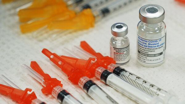 Bivalent COVID-19 vaccines are readied for use at a clinic in Richmond, Va., Nov. 2022. Just 15% of eligible Americans have gotten the most recent booster shot, according to the CDC.