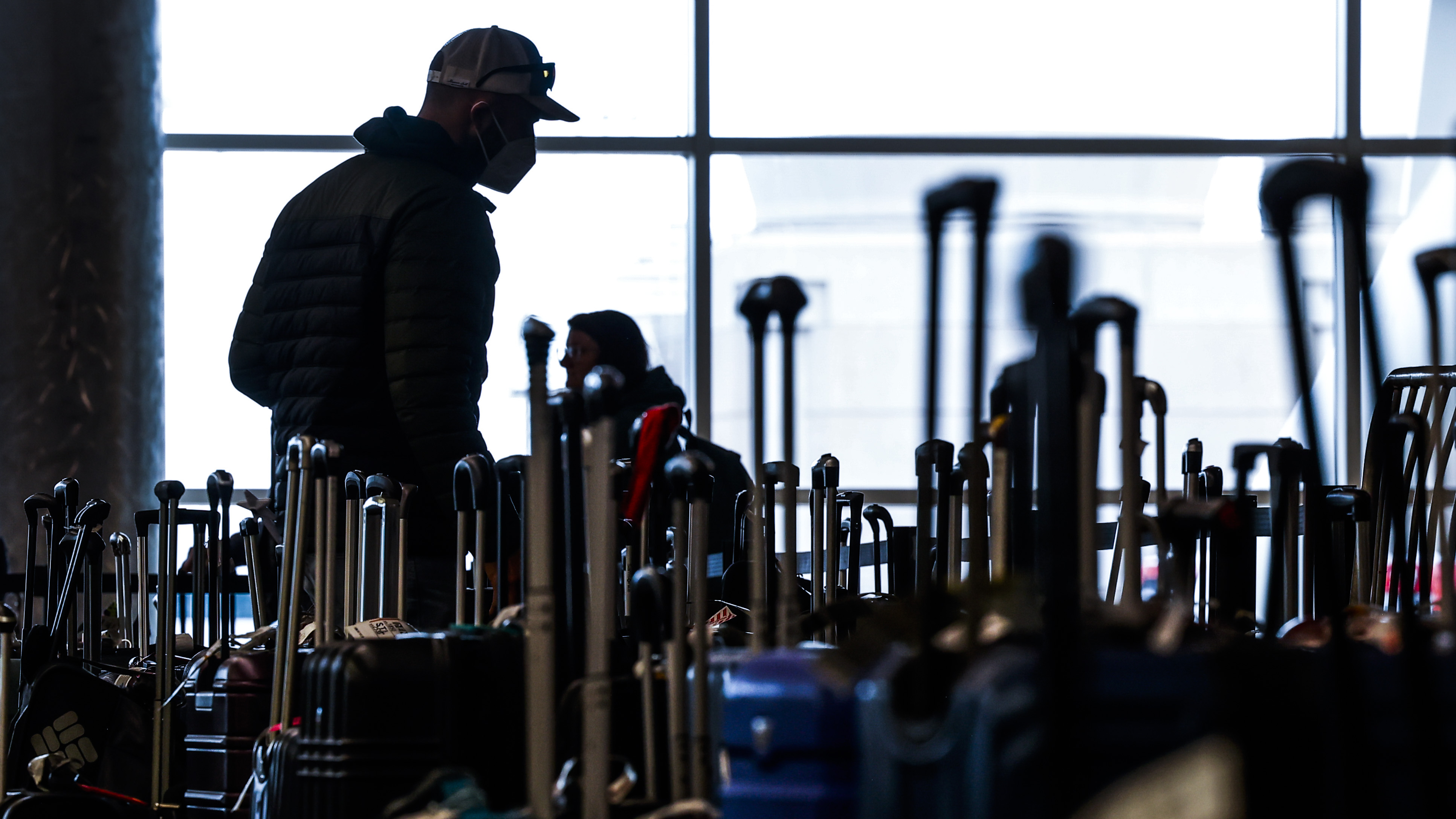 Travelers search for their suitcases in a baggage holding area for Southwest Airlines at Denver International Airport on Dec. 28 in Denver, Colo. (Getty Images)