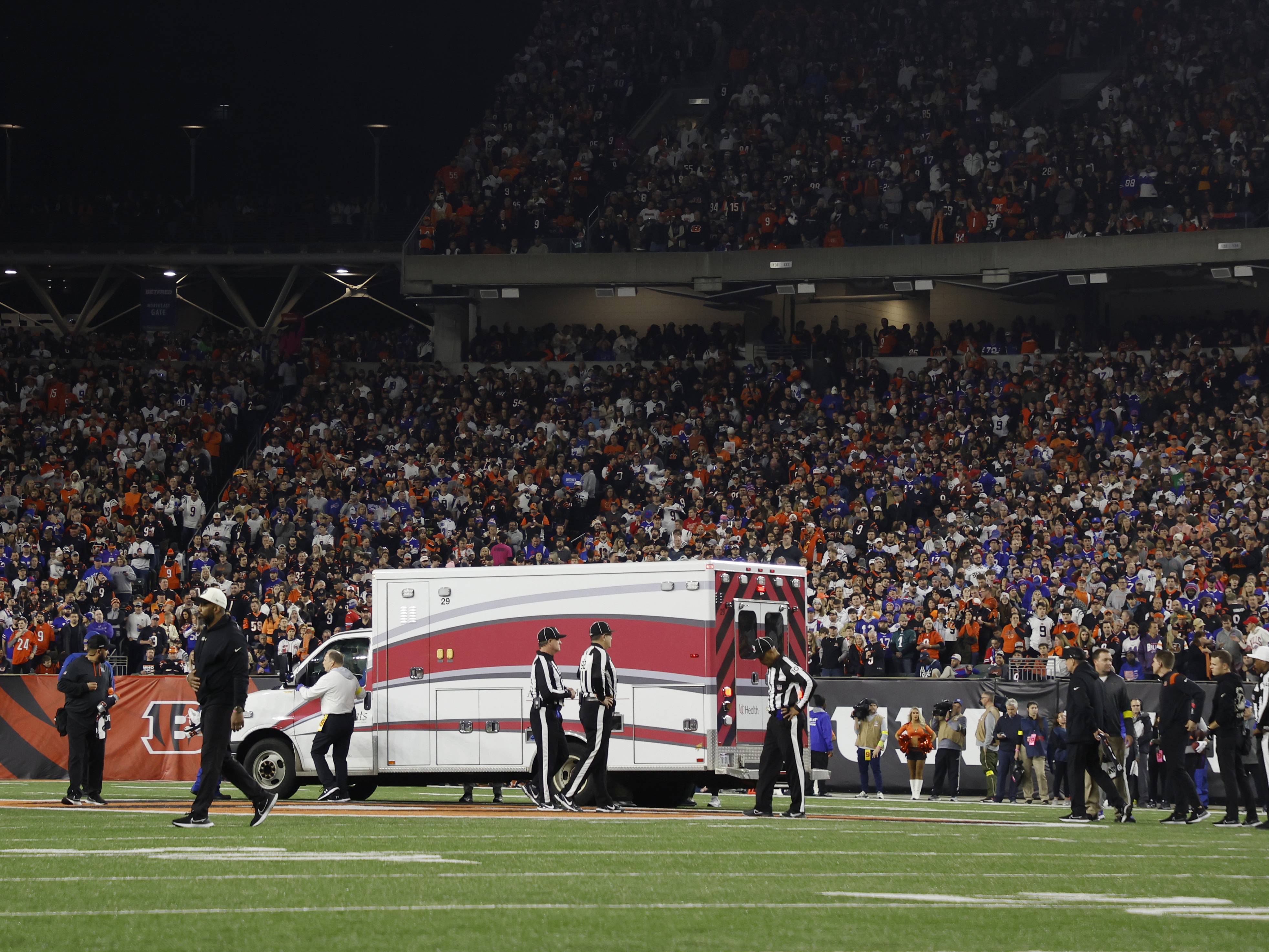 Fans watch as Buffalo Bills football player Damar Hamlin leaves Cincinnati's Paycor Stadium in an ambulance on Monday night after experiencing a cardiac arrest during a game. (Getty Images)