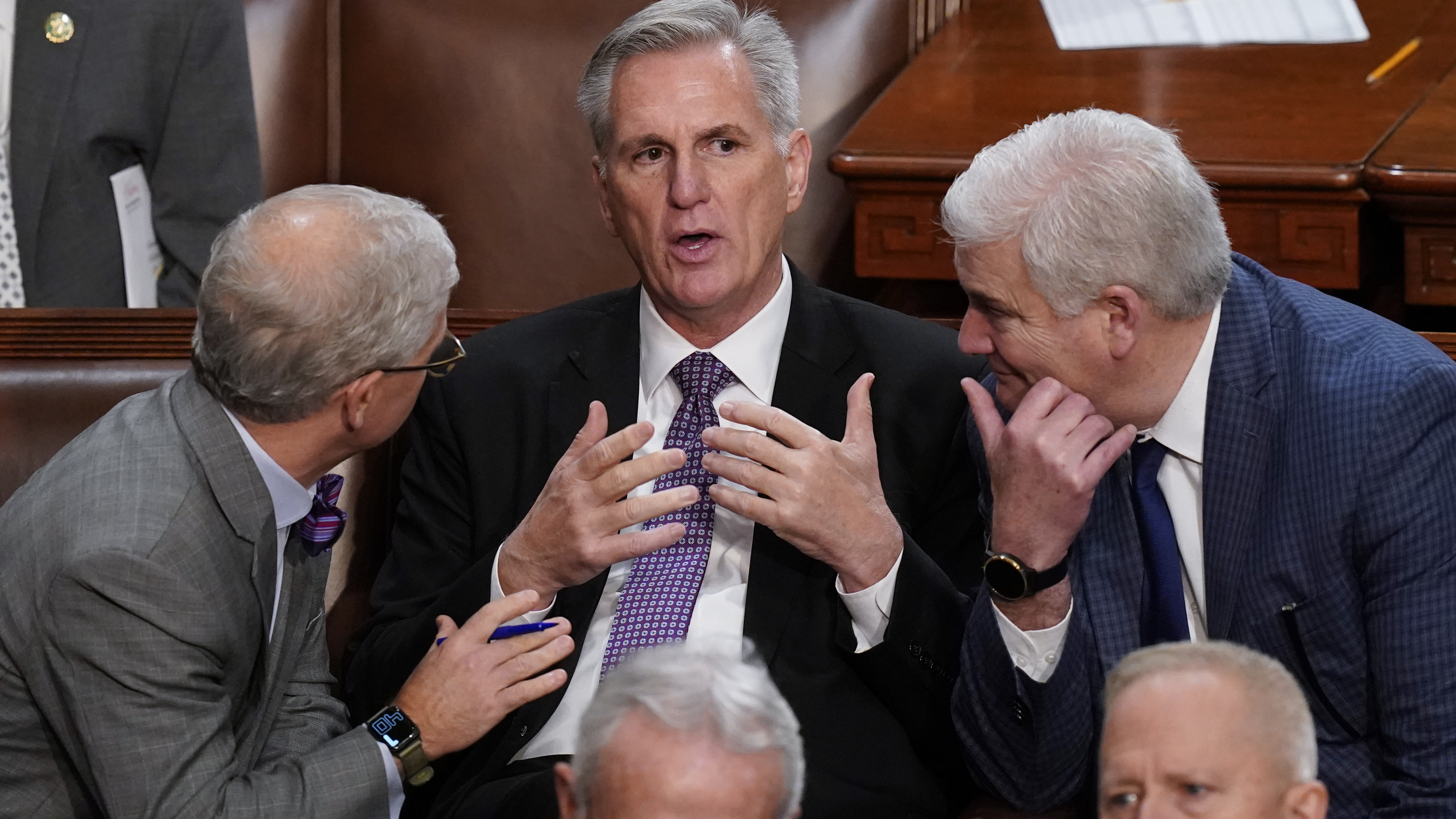 Rep. Kevin McCarthy, R-Calif., is flanked by Rep. Patrick McHenry, R-N.C., left, and Rep. Tom Emmer, R-Minn., right, in the House chamber as lawmakers meet for a second day to elect a speaker and convene the 118th Congress.