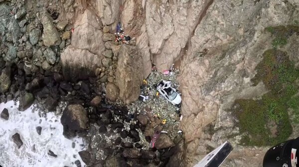 A Tesla with four people inside crashed on the rocks over the cliffside off California's Highway 1 south of San Francisco on Monday. The driver has been arrested with intentionally driving the car off the cliff in an attempt to kill his family.