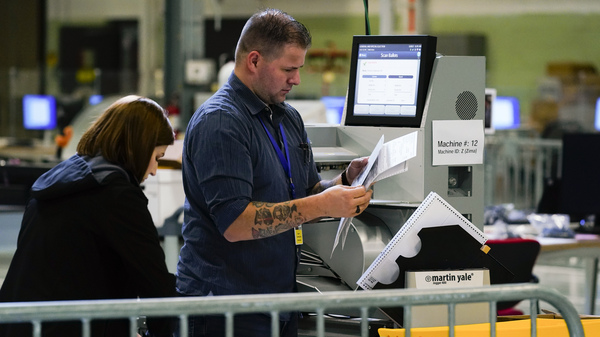 Election workers process mail ballots for the midterm elections in Philadelphia on Nov. 8, 2022.