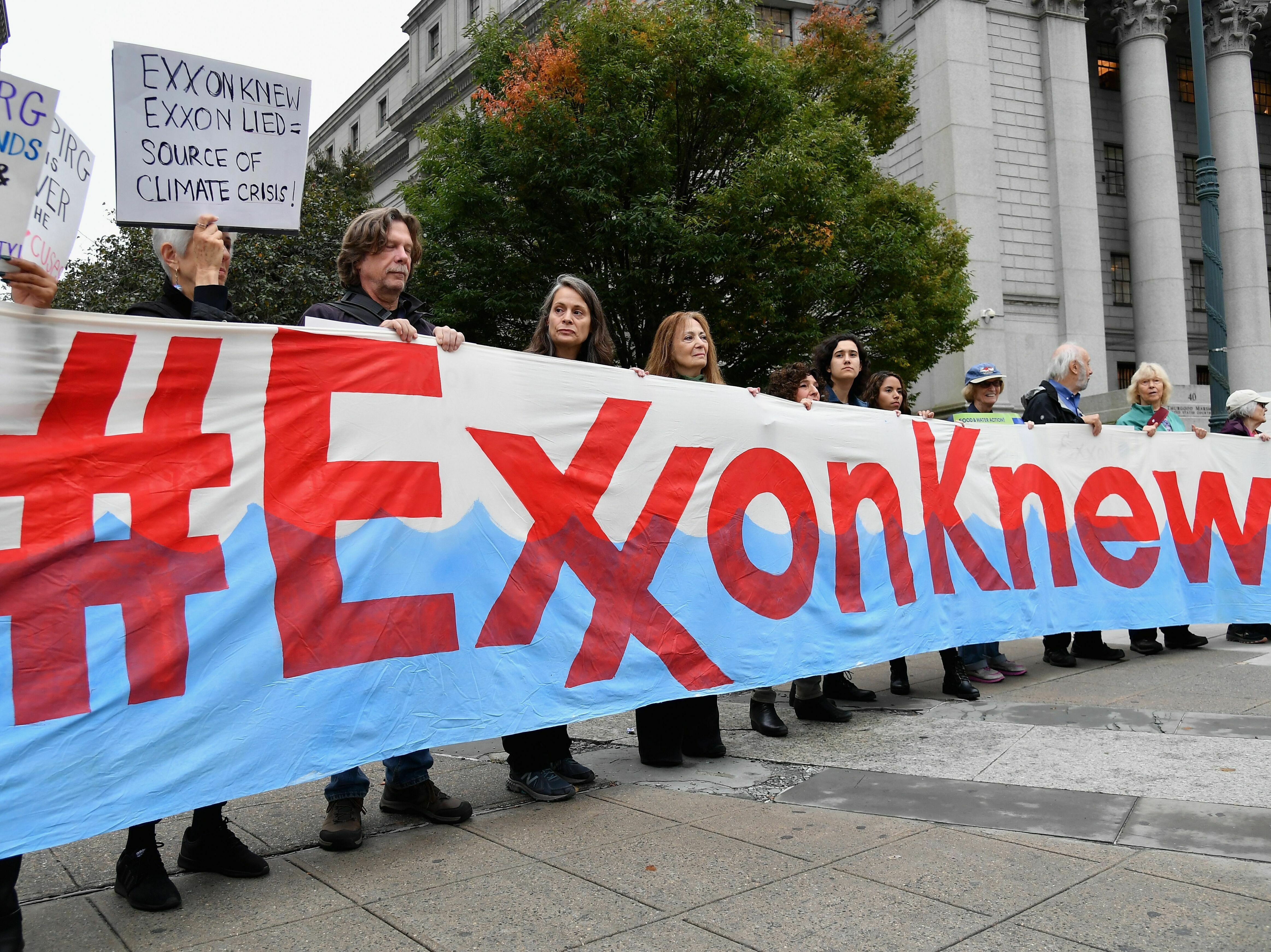 Climate activists protest on the first day of the ExxonMobil trial outside the New York State Supreme Court building on Oct. 22, 2019, in New York City. ExxonMobil was found not guilty of misleading investors about how climate change would affect its finances. (AFP via Getty Images)