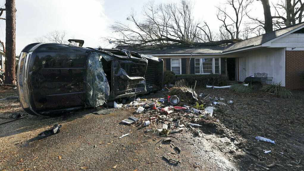 A vehicle is upended and debris is strewn about Thursday following a tornado near Meadowview Elementary Schoolin Selma, Ala.