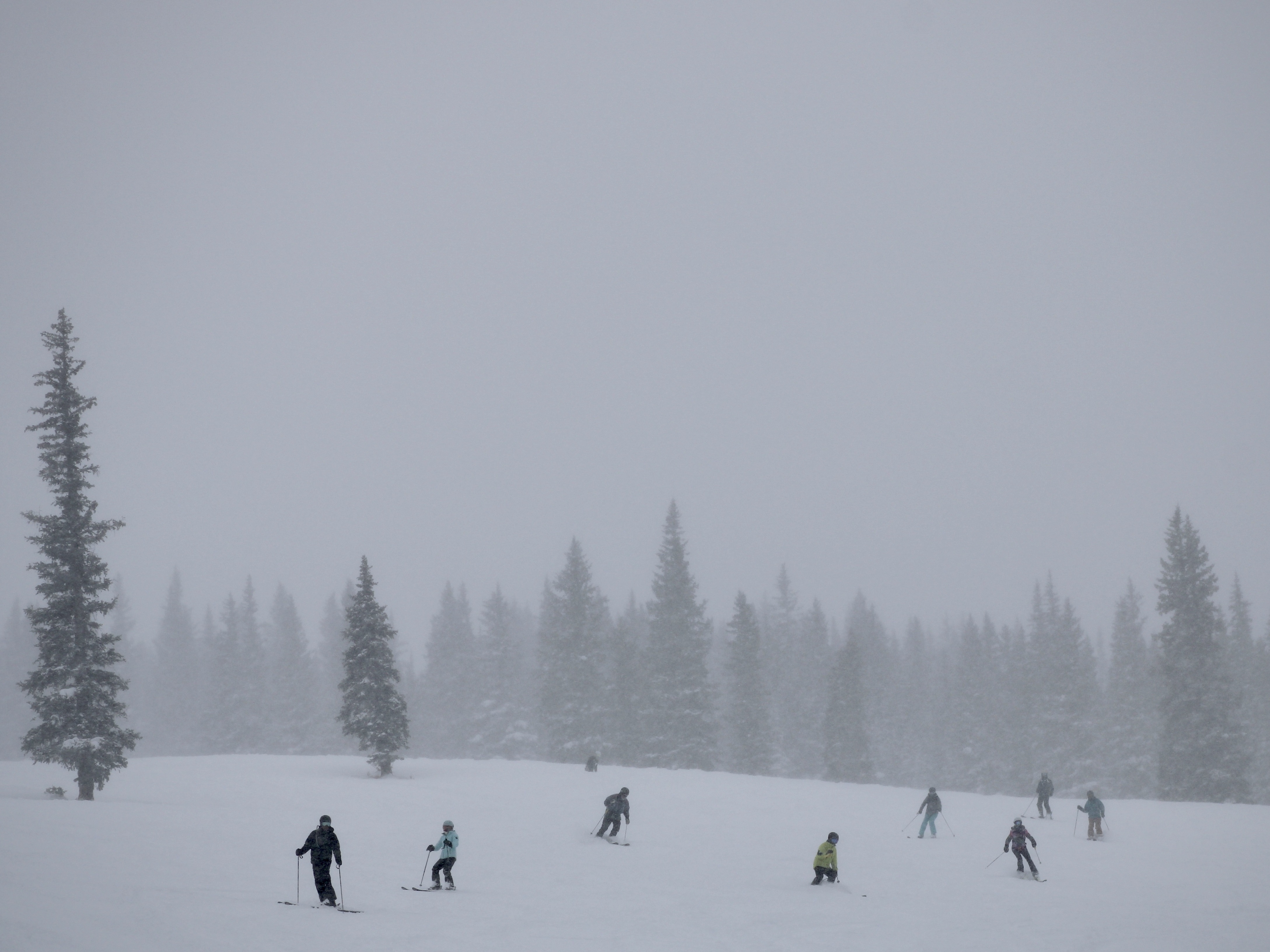 Skiers cruise down the slopes at Snowmass ski area in Colorado. This winter has already delivered snow totals above 130% of average, but climate scientists say it will take more than one wet winter to pull the arid West out of a 23-year drought. (KUNC)