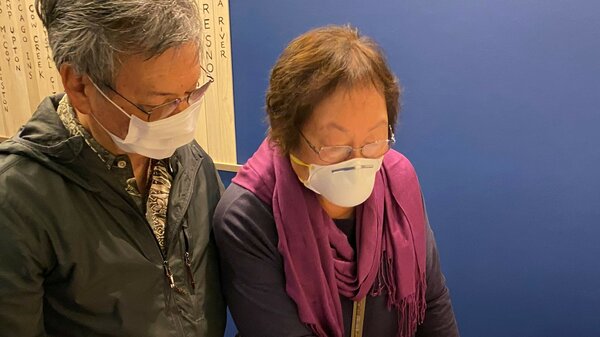 Frances and Ford Kuramoto visiting the Ireichō at the Japanese American National Museum in Los Angeles. The book collects the names of those interned at camps during the war.