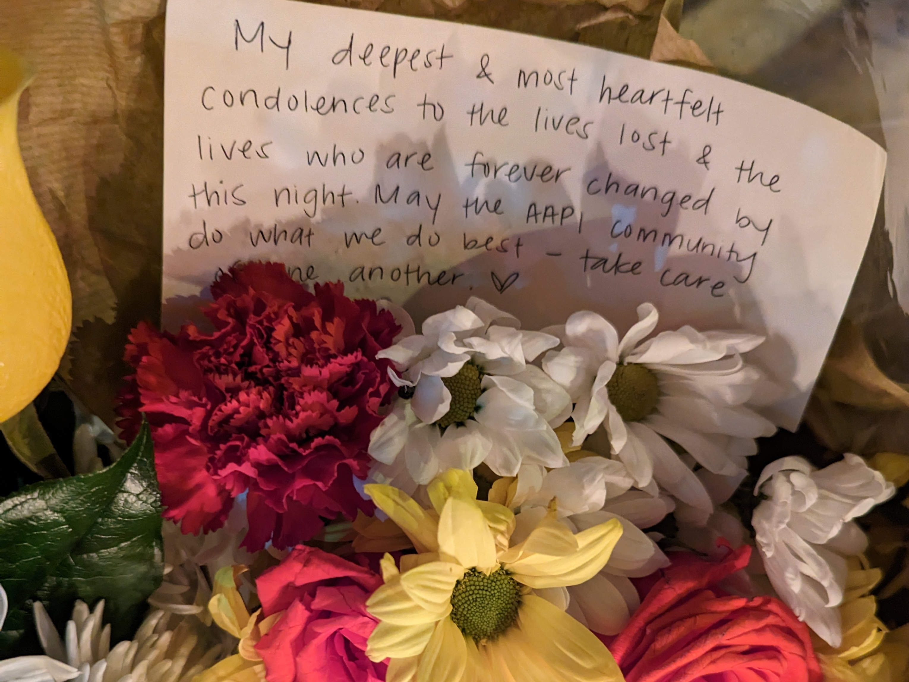 Makeshift vigils of candles, flowers and notes started to appear on Sunday after the shooting. One note read "My deepest [and] most heartfelt condolences to the lives lost [and] the lives who are forever changed by this night. May the AAPI community do what we do best — take care of one another."