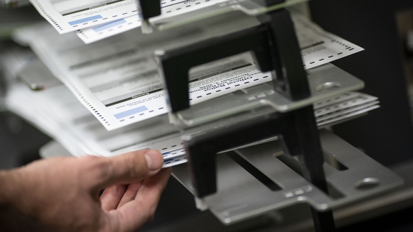 Workers sort absentee ballots in Kenosha, Wis.