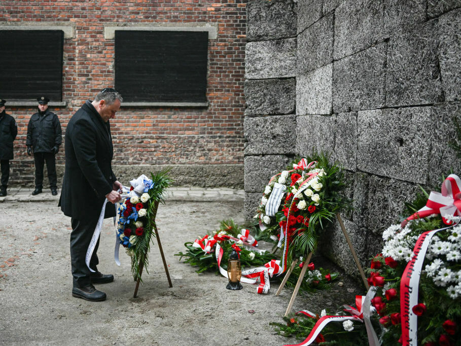 U.S. second gentleman, Doug Emhoff, lays a wreath honoring Holocaust victims at the former Auschwitz site on Friday in Oswiecim, Poland. (Getty Images)