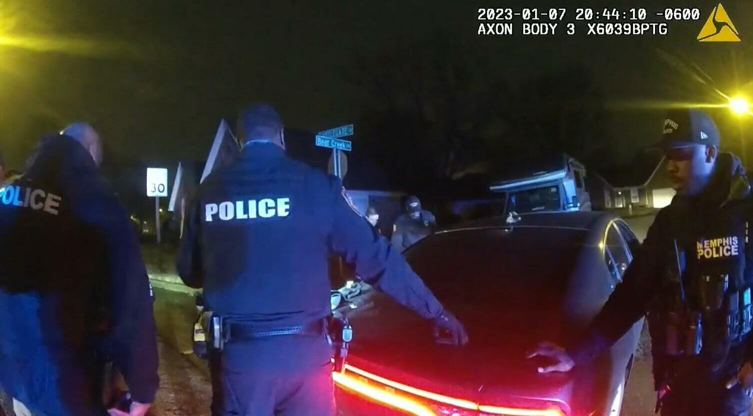 Police officers, who were seen on camera beating and kicking Tyre Nichols, stand by where Nichols is slumped over on the ground. This image is a screenshot of one of the videos from graphic police body camera footage released to the public on Friday night. (City of Memphis Vimeo/Screenshot by NPR)