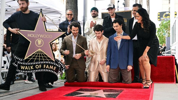 The Jonas Brothers react as their Hollywood Walk of Fame Star is unveiled during a ceremony on Monday in Hollywood, Calif. At the ceremony, they announced their sixth album will be released on May 5.