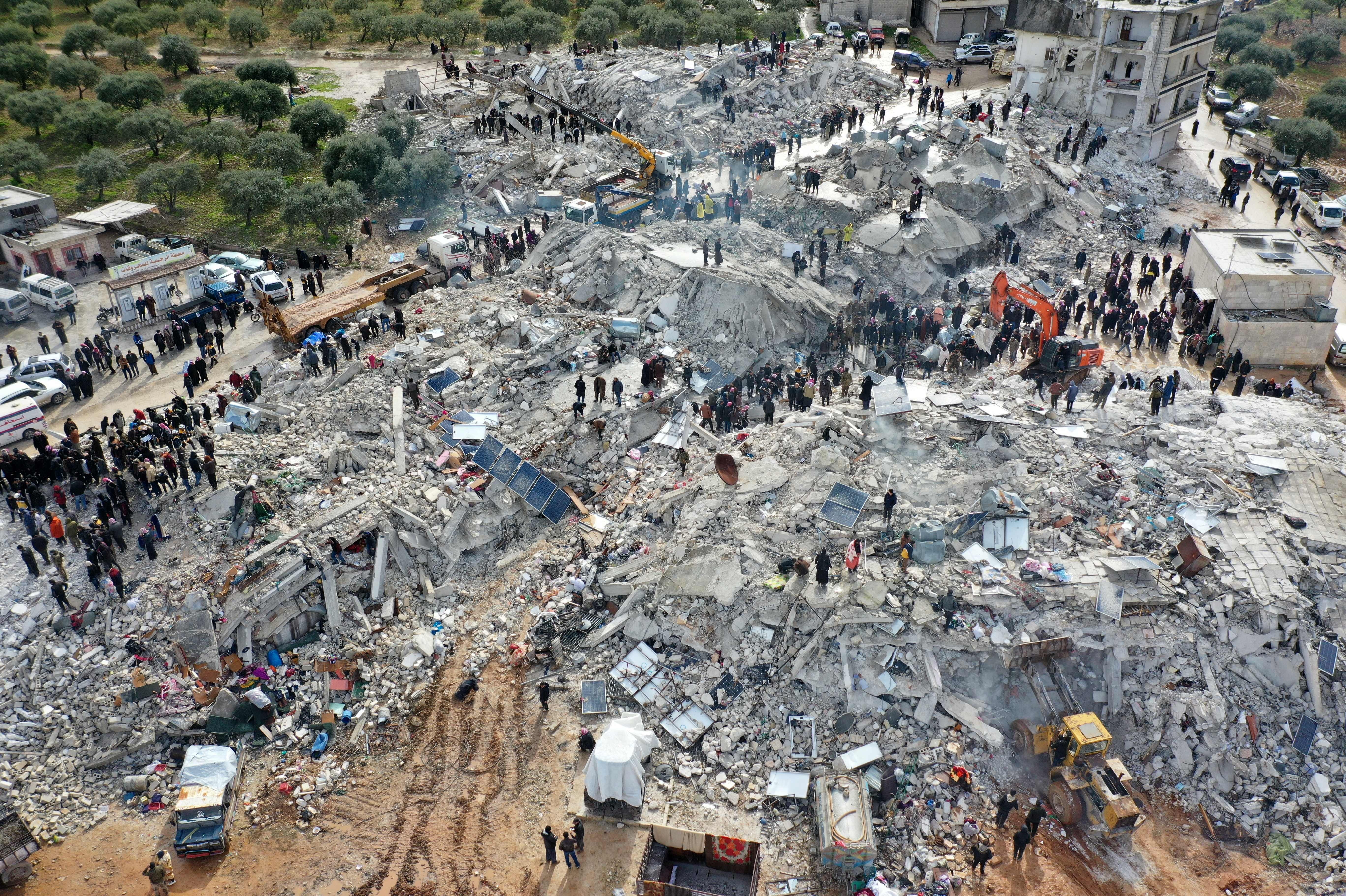 This aerial view shows residents searching for victims and survivors amidst the rubble of collapsed buildings following an earthquake in the village of Besnia near the town of Harim, Syria (Omar Haj Kadour/AFP via Getty Images)
