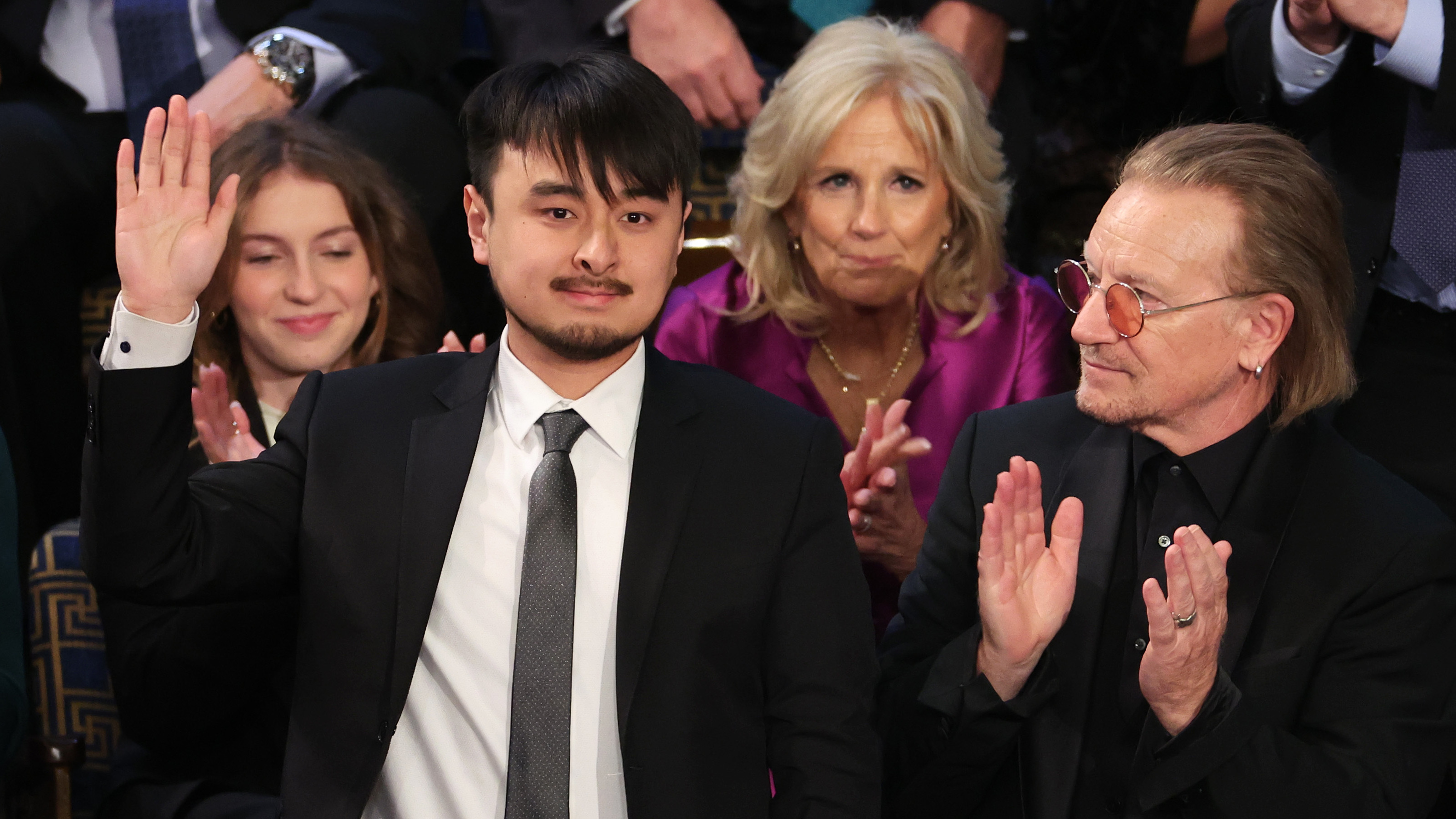 Brandon Tsay (left), who disarmed the gunman in Monterey Park, Calif., in late January, with first lady Jill Biden and Bono at the State of the Union address. (Getty Images)