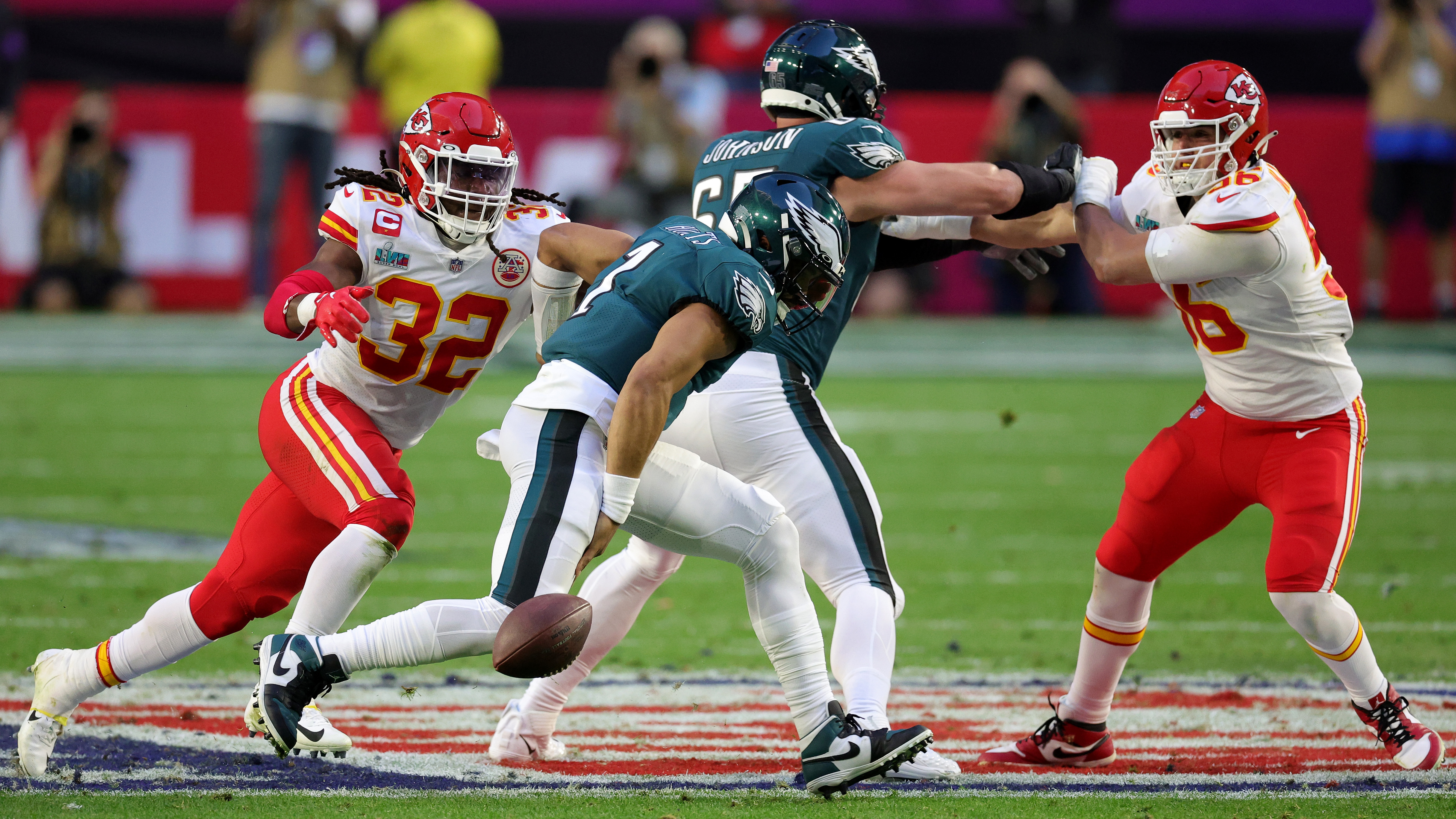 Nick Bolton #32 of the Kansas City Chiefs forces Jalen Hurts #1 of the Philadelphia Eagles to fumble during the second quarter of Super Bowl LVII. Bolton scooped up the ball and scored a touchdown to even the score 14-14.