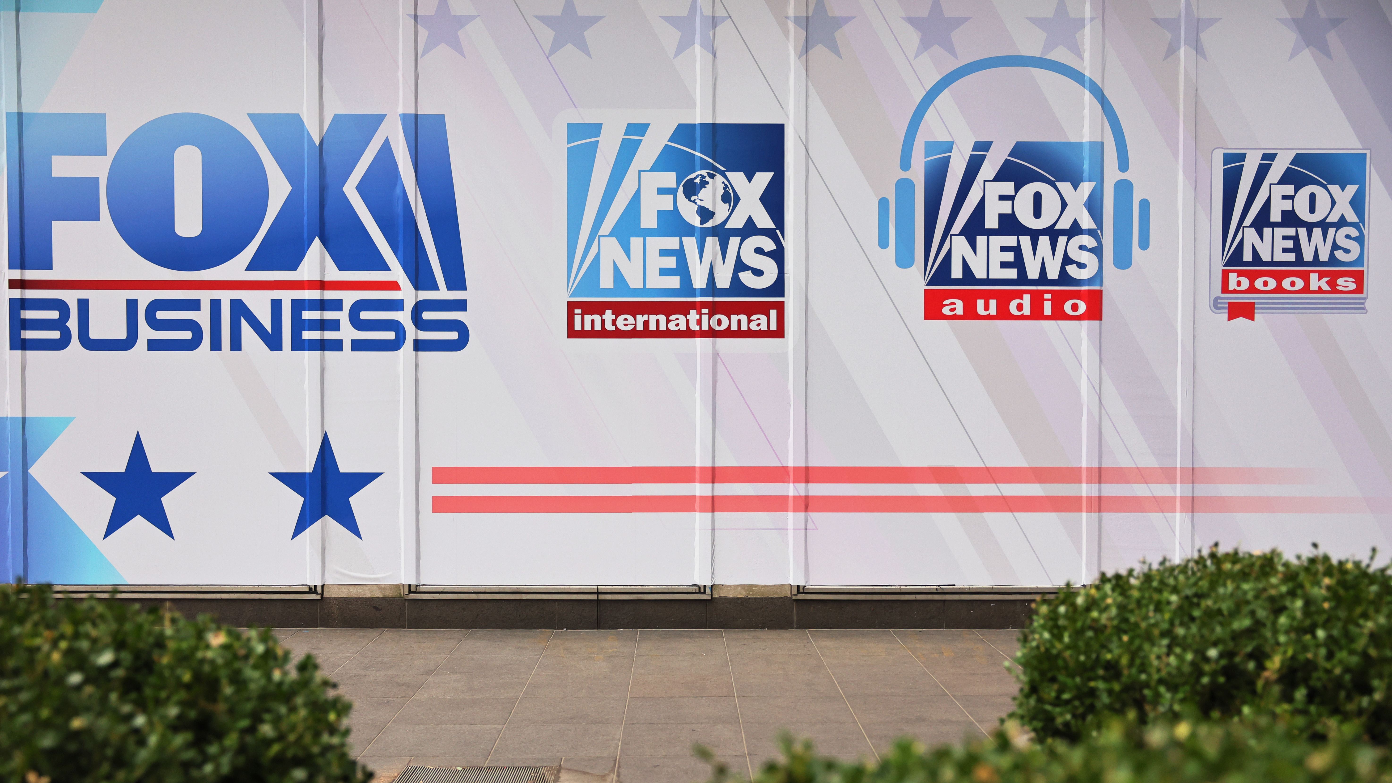 Fox News and its parent company are being sued for defamation over false claims of election fraud following the 2020 election. Above, logos for Fox News Media's growing portfolio of brands adorn its corporate headquarters in New York City. (Getty Images)
