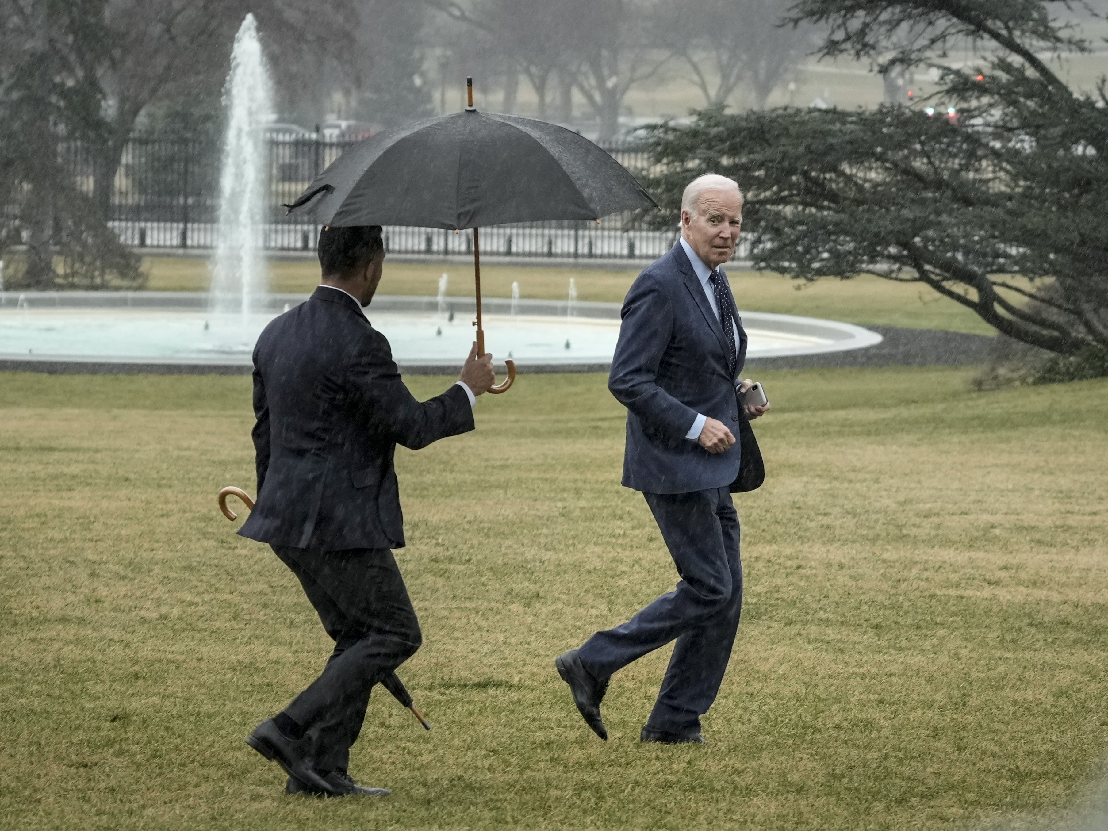 President Biden jogs across the South Lawn of the White House in the rain after getting his latest physical on Feb. 16. (Getty Images)