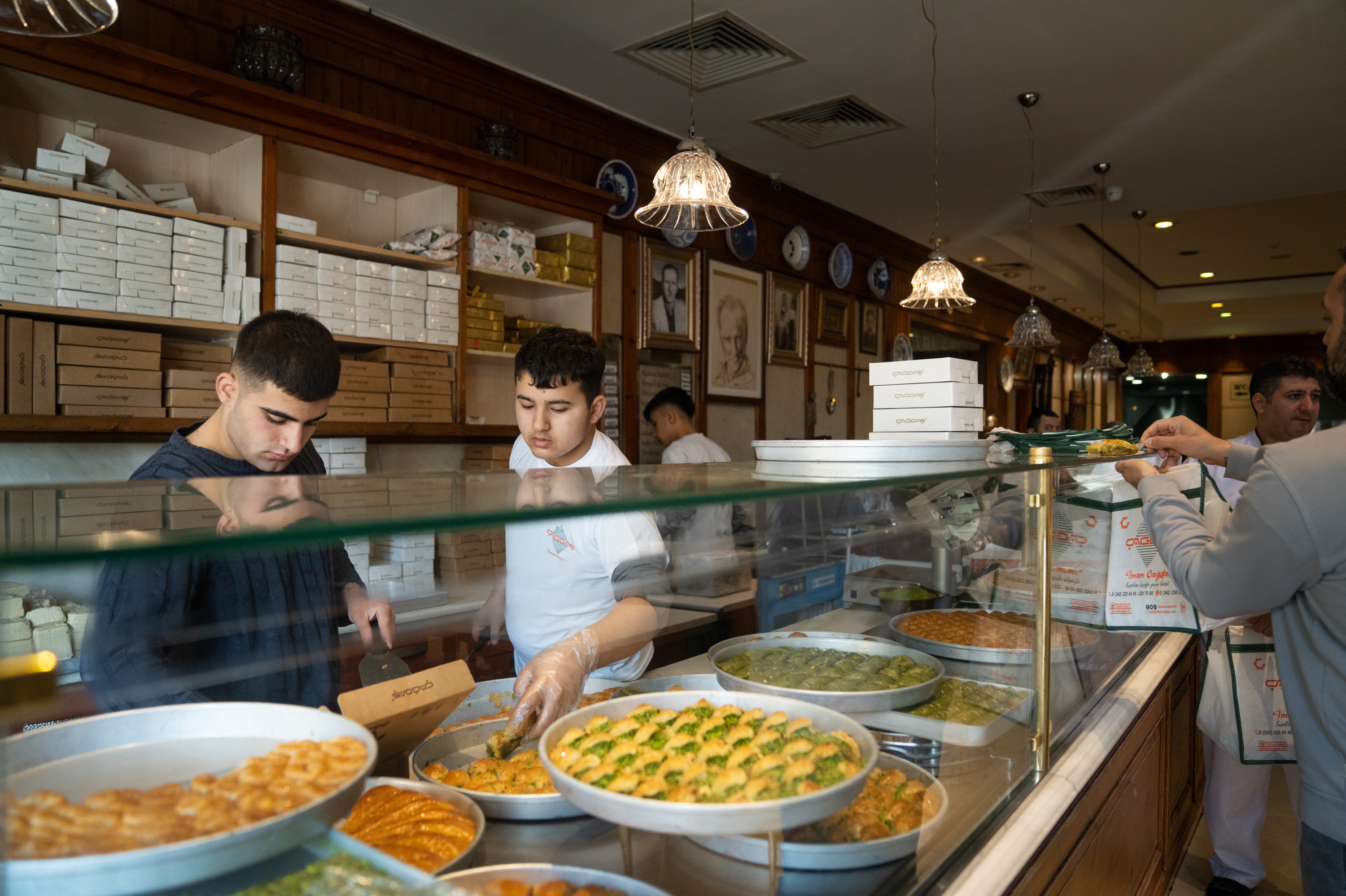Employees box up baklava for customers at Imam Cagdas in Gaziantep, Turkey.