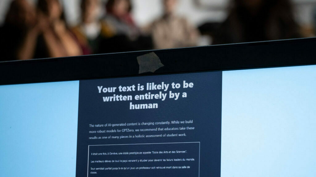 Teachers are seen behind a laptop during a workshop on ChatGpt bot organised for by the School Media Service (SEM) of the Public education of the Swiss canton of Geneva. (AFP via Getty Images)