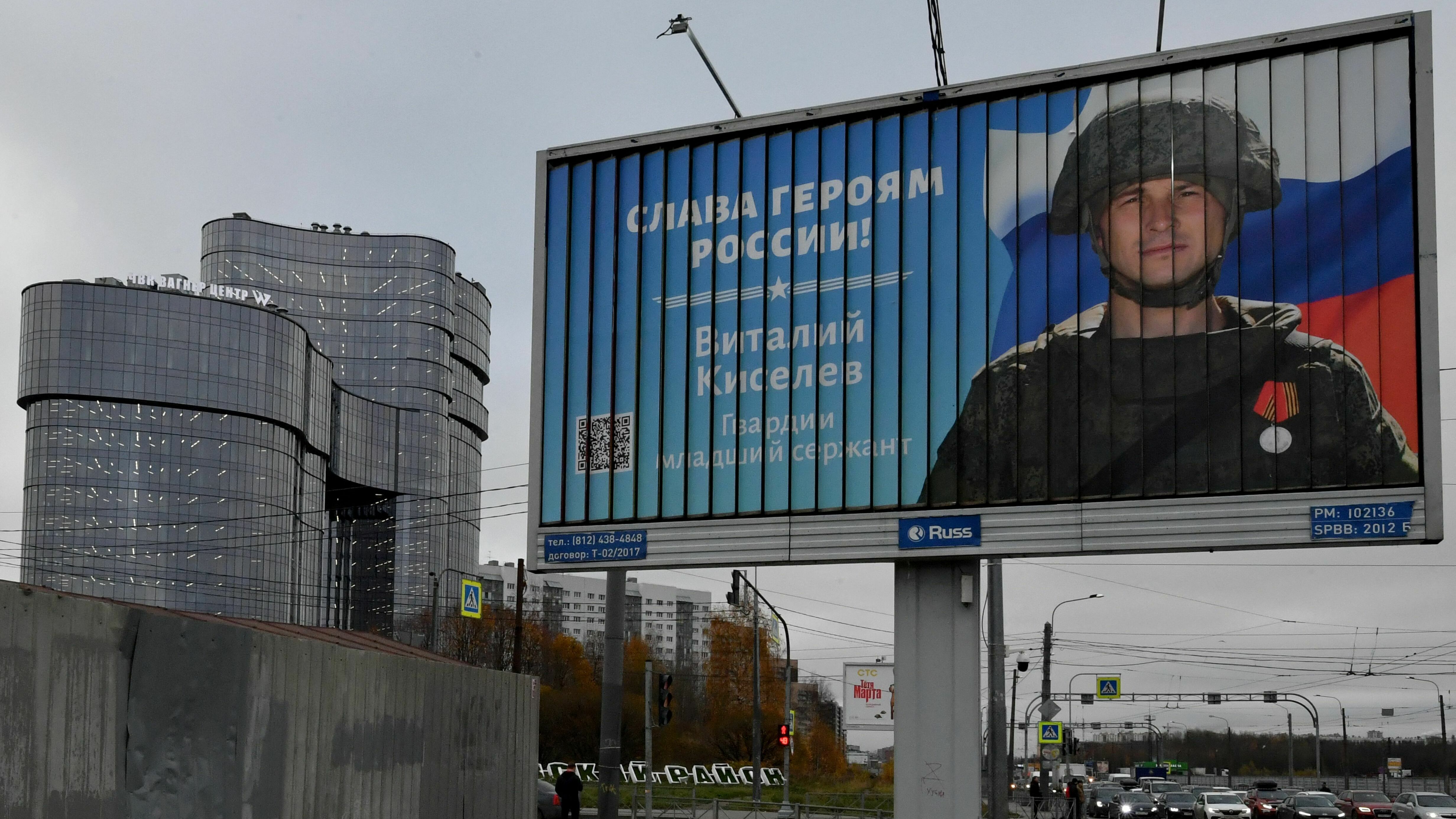 A poster displays a Russian soldier with a slogan reading &quot;Glory to the Heroes of Russia.&quot; (AFP via Getty Images)