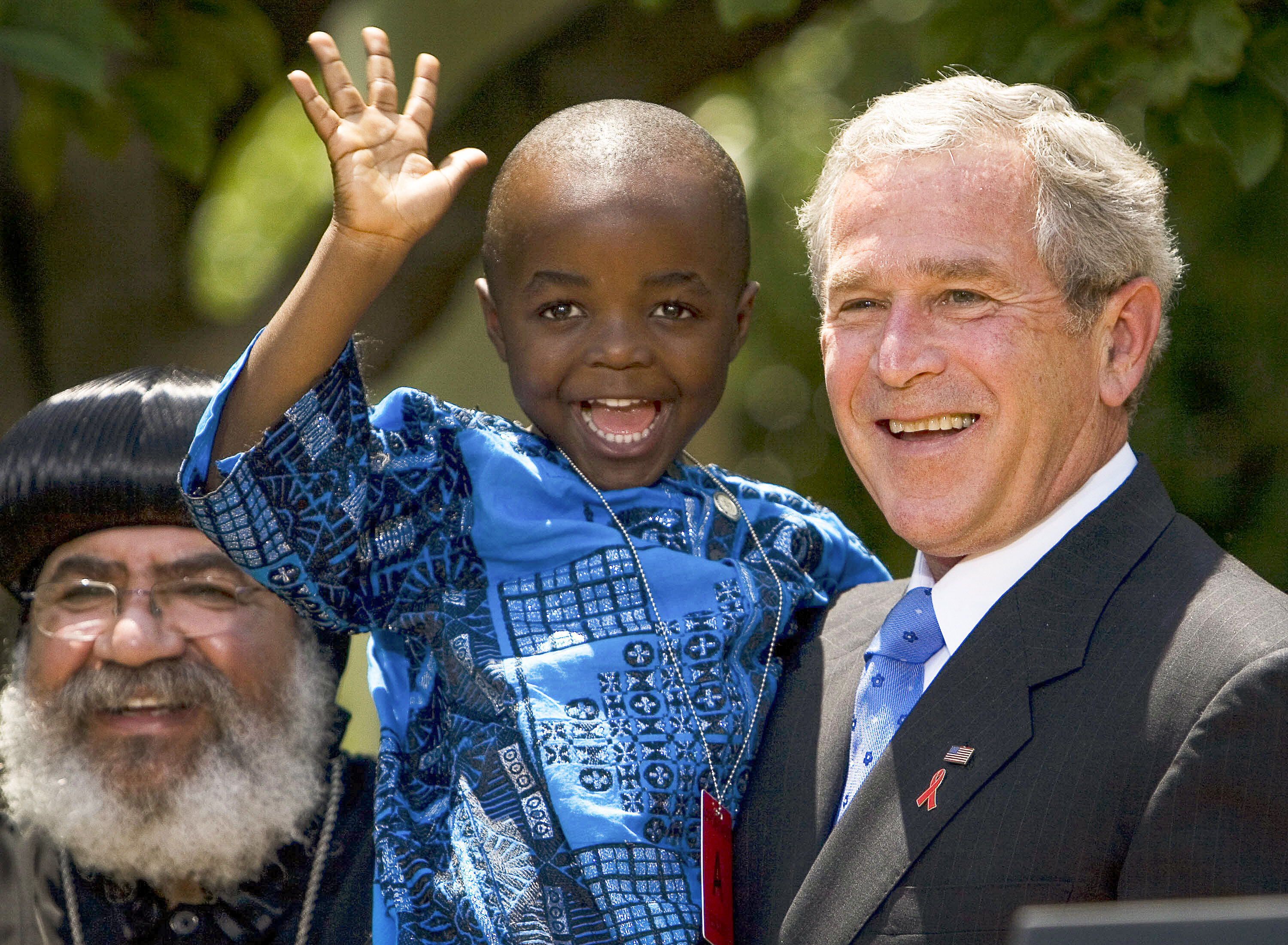 In 2003, President George W. Bush created PEPFAR to help countries tackle the HIV/AIDS crisis. Four years later, he spoke at the Rose Garden to urge lawmakers to set aside $30 billion for the cause over the next 5 years. Joining him were Kunene Tantoh of South Africa and her 4-year-old son (pictured). Tantoh, who is HIV-positive, coordinated a U.S.-funded mentoring program for mothers with HIV. (Mandel Ngan/AFP via Getty Images via Getty Images)