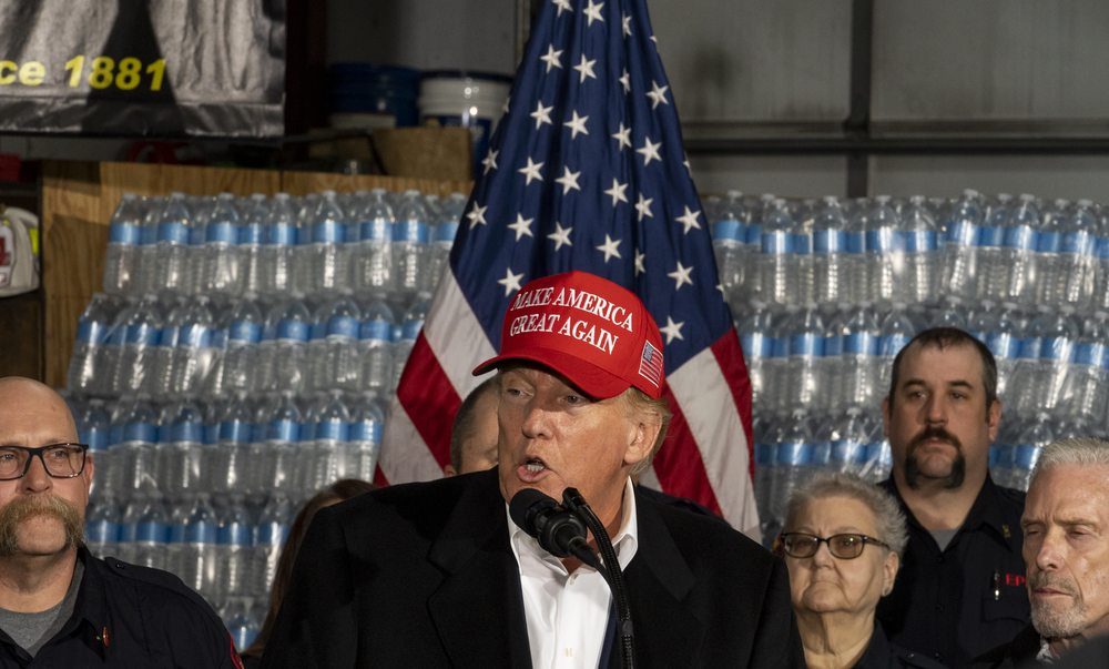 During a visit to East Palestine, Ohio, former President Donald Trump stands in front of a pallet of "Trump"-branded water before delivering remarks at the East Palestine Fire Department station Wednesday. (Getty Images)
