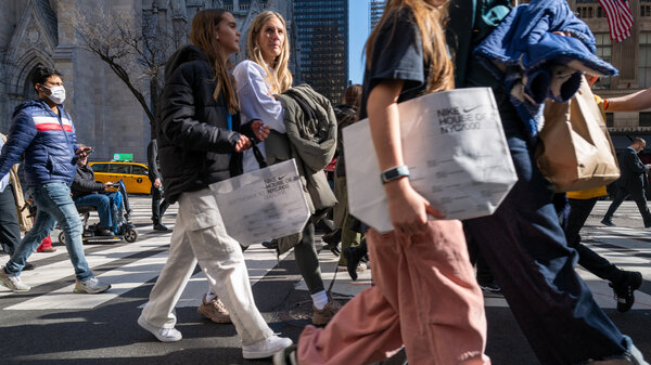 People walk along 5th Avenue in Manhattan, which is one of the nation's premier shopping streets, on Feb. 15, 2023. Consumer spending was unexpectedly strong last month. That's good for the economy – but not so good for inflation prospects.
