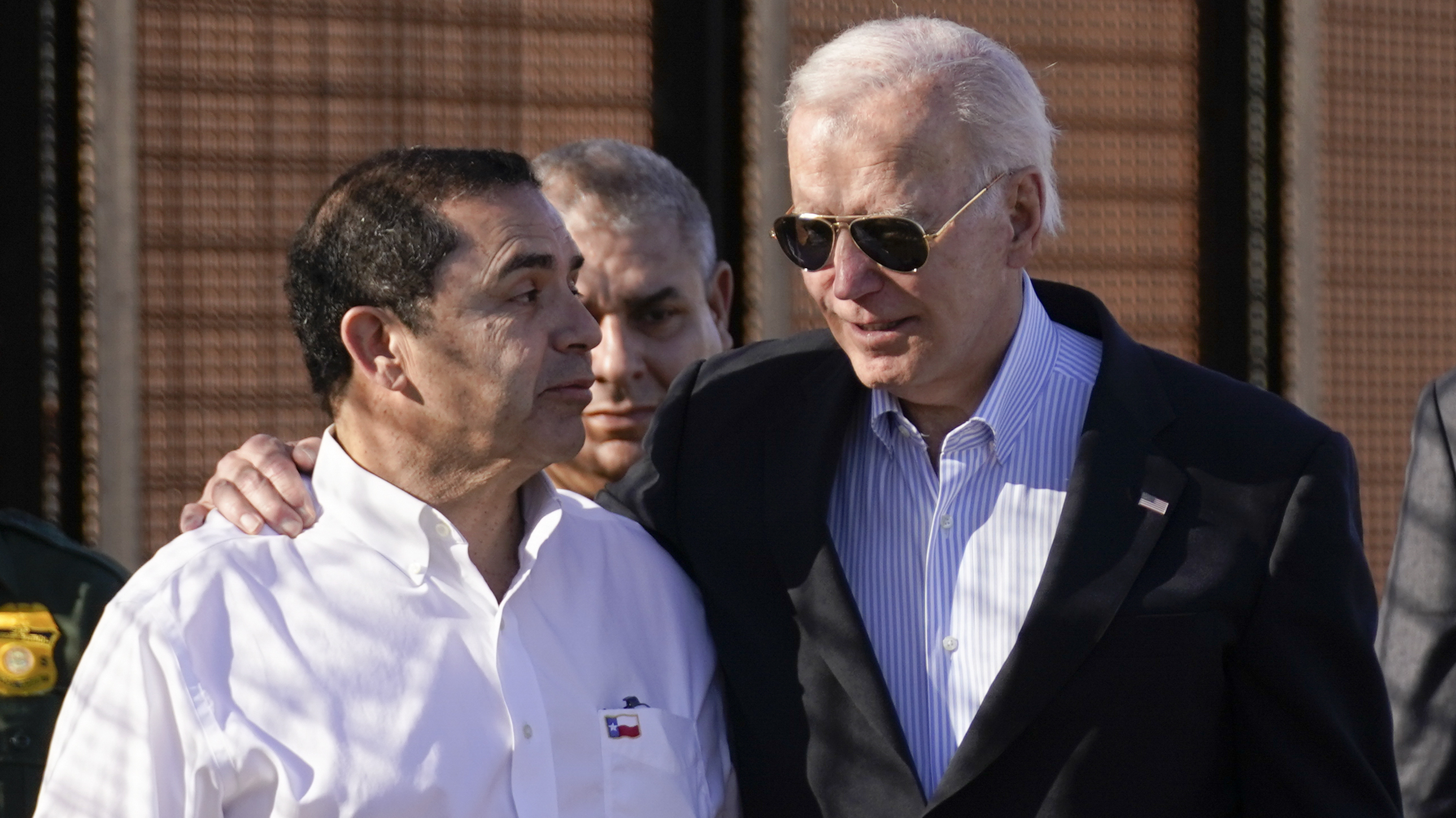 President Joe Biden talks with Rep. Henry Cuellar, D-Texas, left, as they walk along a stretch of the U.S.-Mexico border in El Paso Texas, last month.