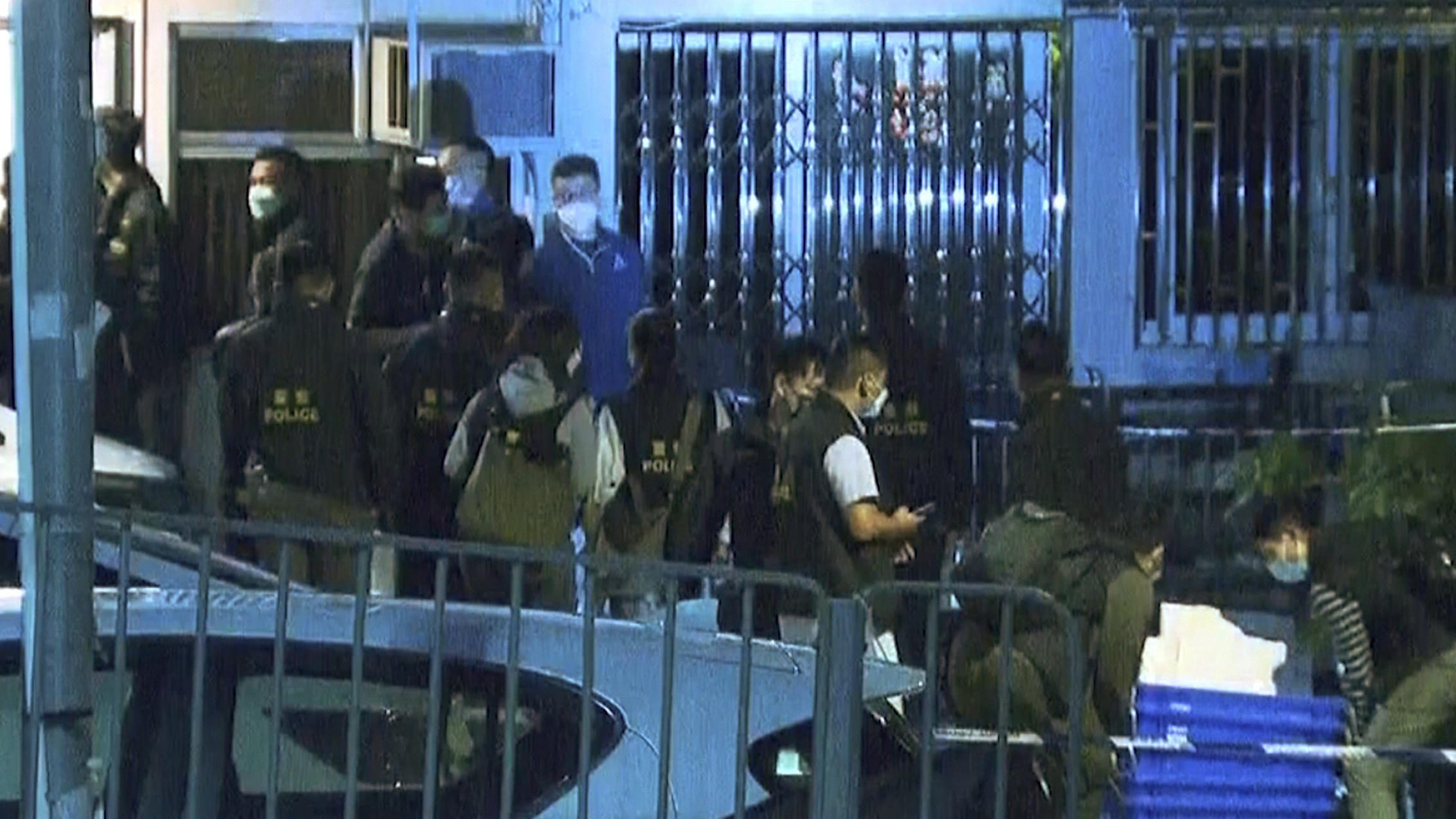 In this image taken from video footage provided by TVB Hong Kong, police officers search a village home where they found body parts related to a missing model in a murder case, in Hong Kong on Sunday, Feb. 26, 2023.