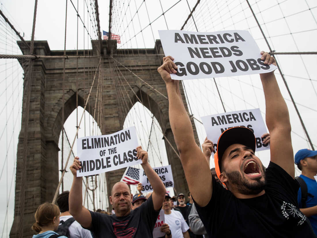 Following a rally in Brooklyn's Cadman Plaza Park, hundreds of union members march across the Brooklyn Bridge in support of IBEW Local 3 (International Brotherhood of Electrical Workers), September 18, 2017, in New York City.