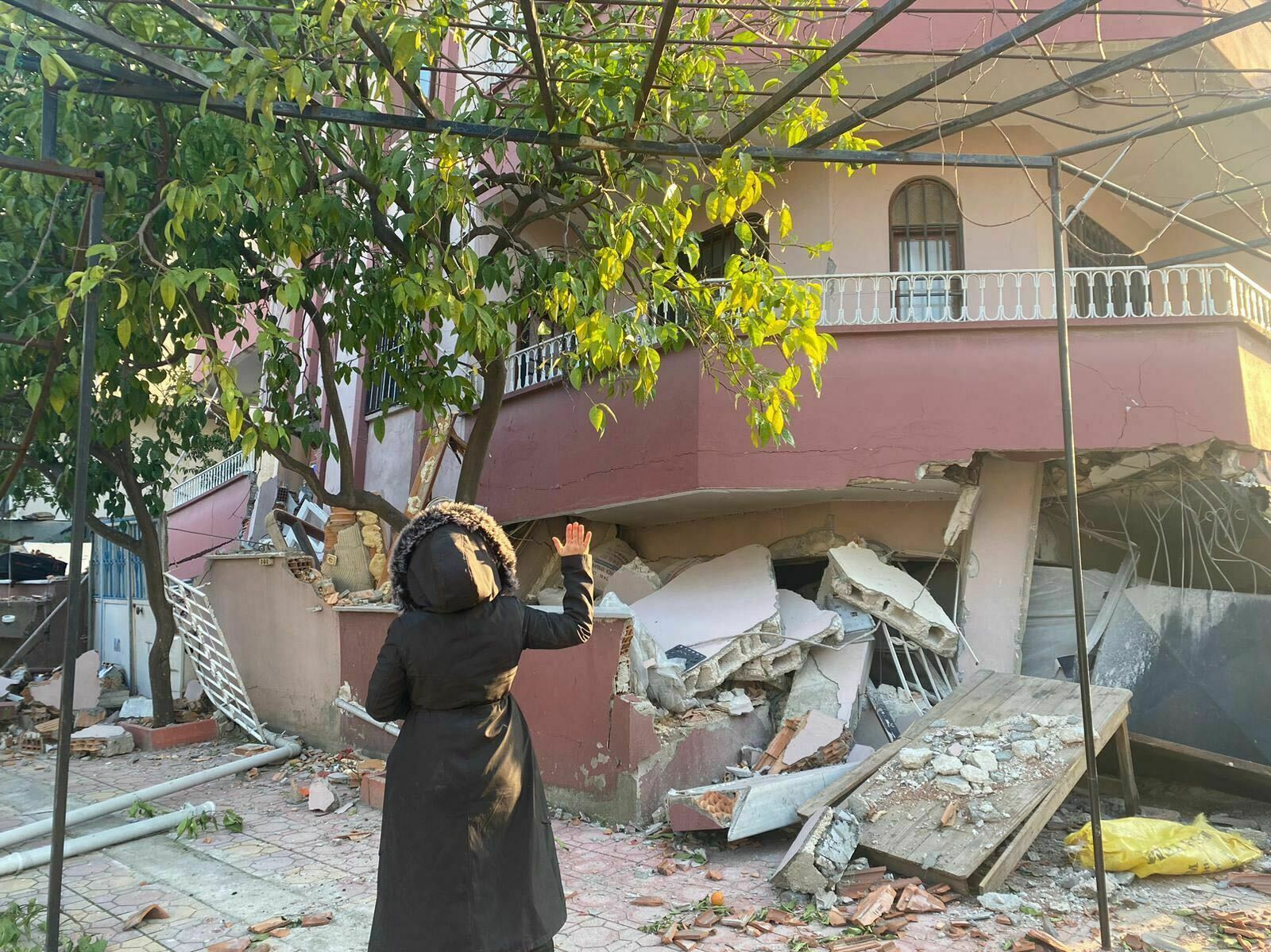 Assalah Shikhani in front of her collapsed home in Antakya, Turkey. (Assalah Shikhani)