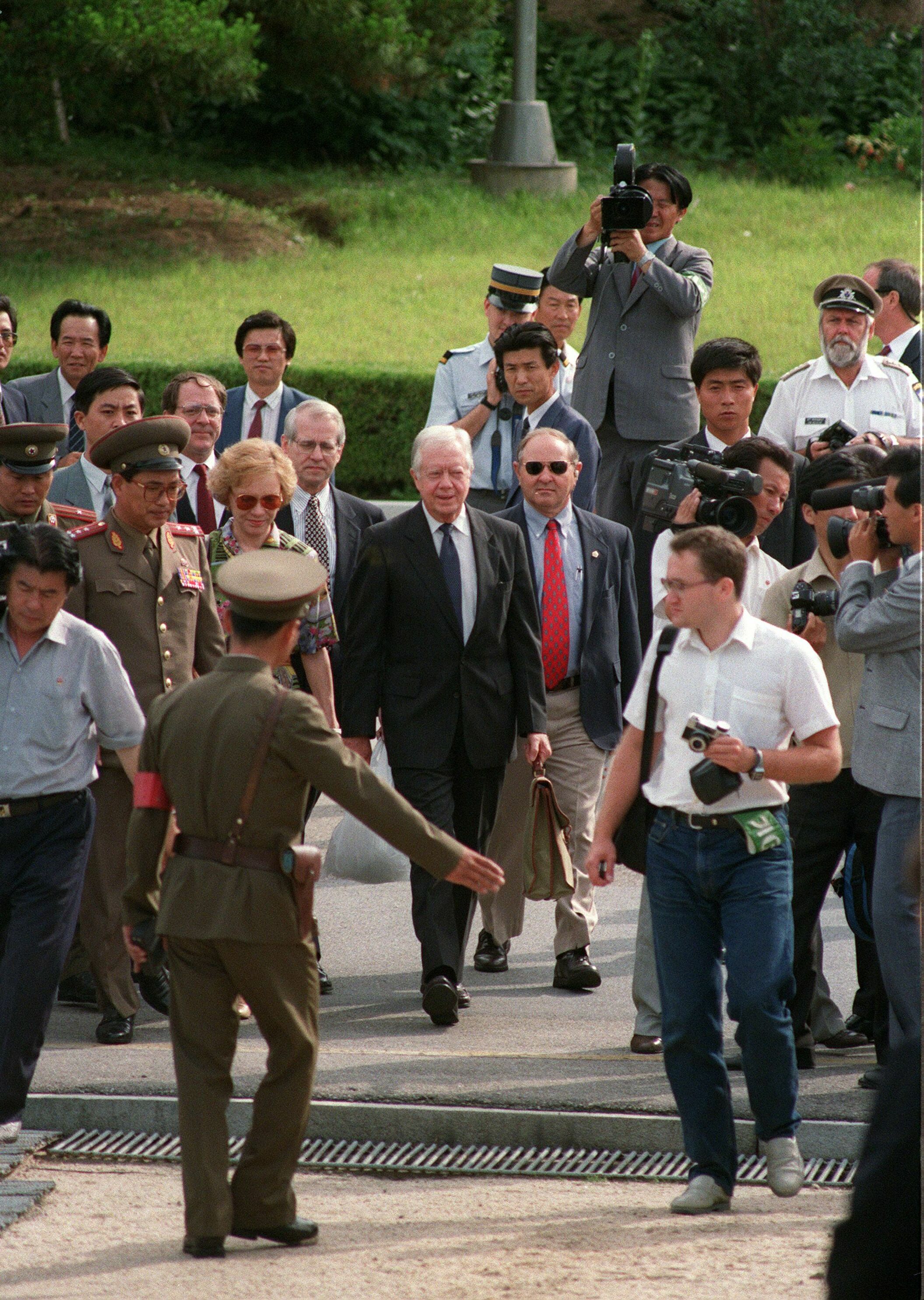June 18, 1994: North Korean border guard showing a weary-looking former US President Jimmy Carter (C) and his wife Rosalynn (L), the way to the South Korea side of the demilitarized zone (DMZ) as they leave  North Korea through Panmunjom border village after Carter