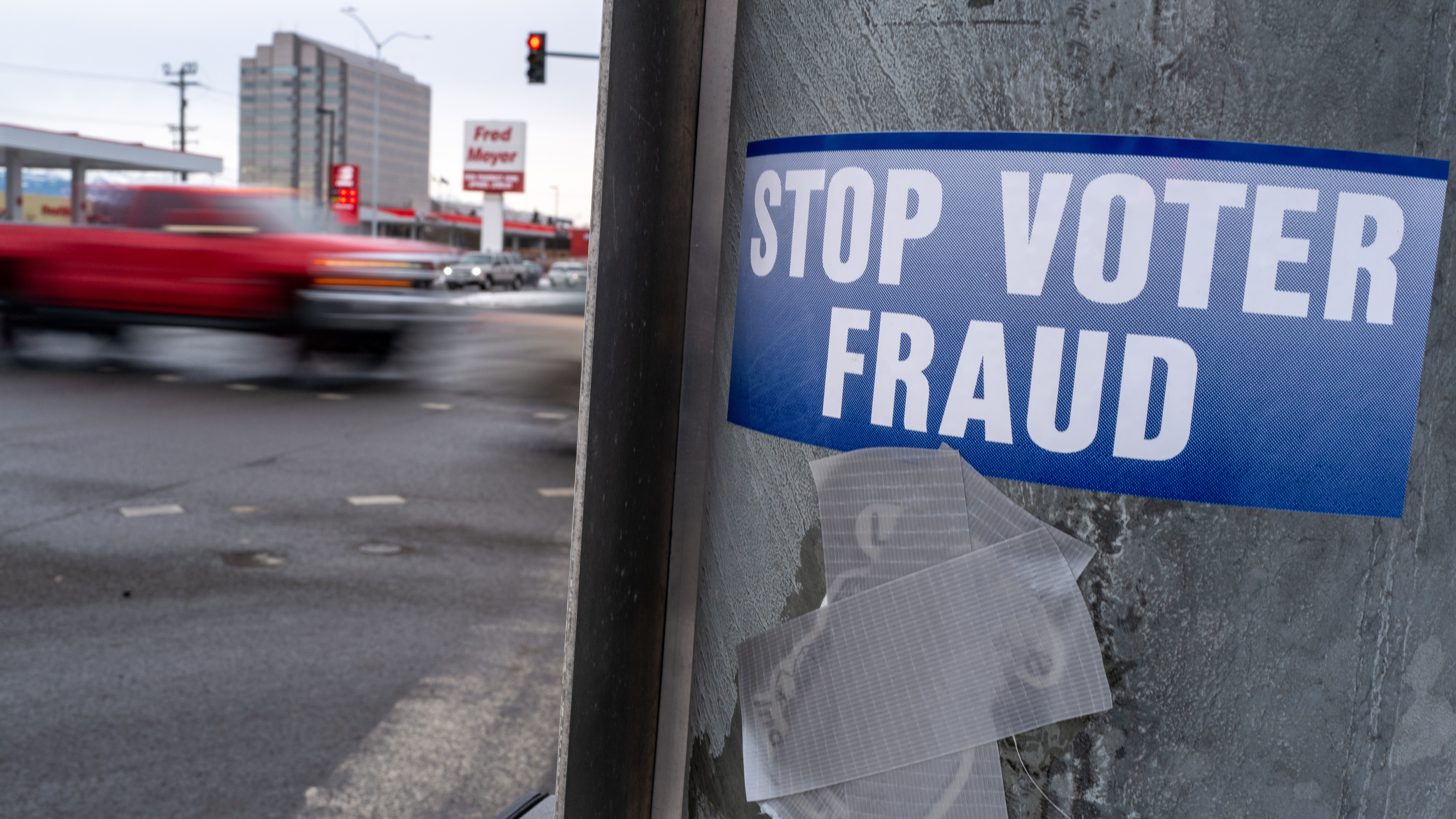A sticker on a lamp post warns of voter fraud on Nov. 7, 2022, in Anchorage, Alaska. Alaska is part of a bipartisan compact of more than 30 states that shares voting data. (Getty Images)