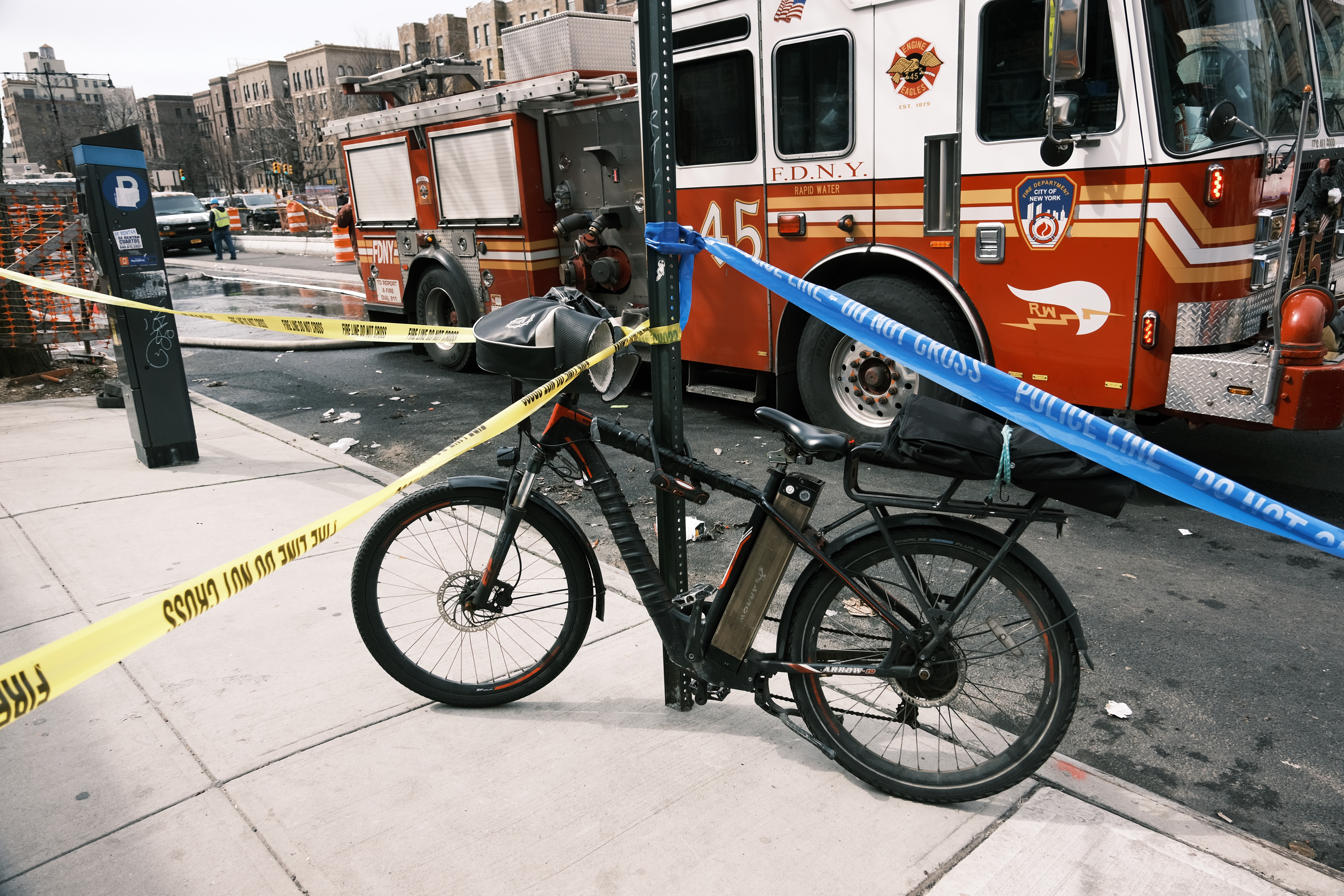 An electric bike parked near a Bronx supermarket that was destroyed in a fire that officials say was caused by a faulty lithium-ion scooter battery.