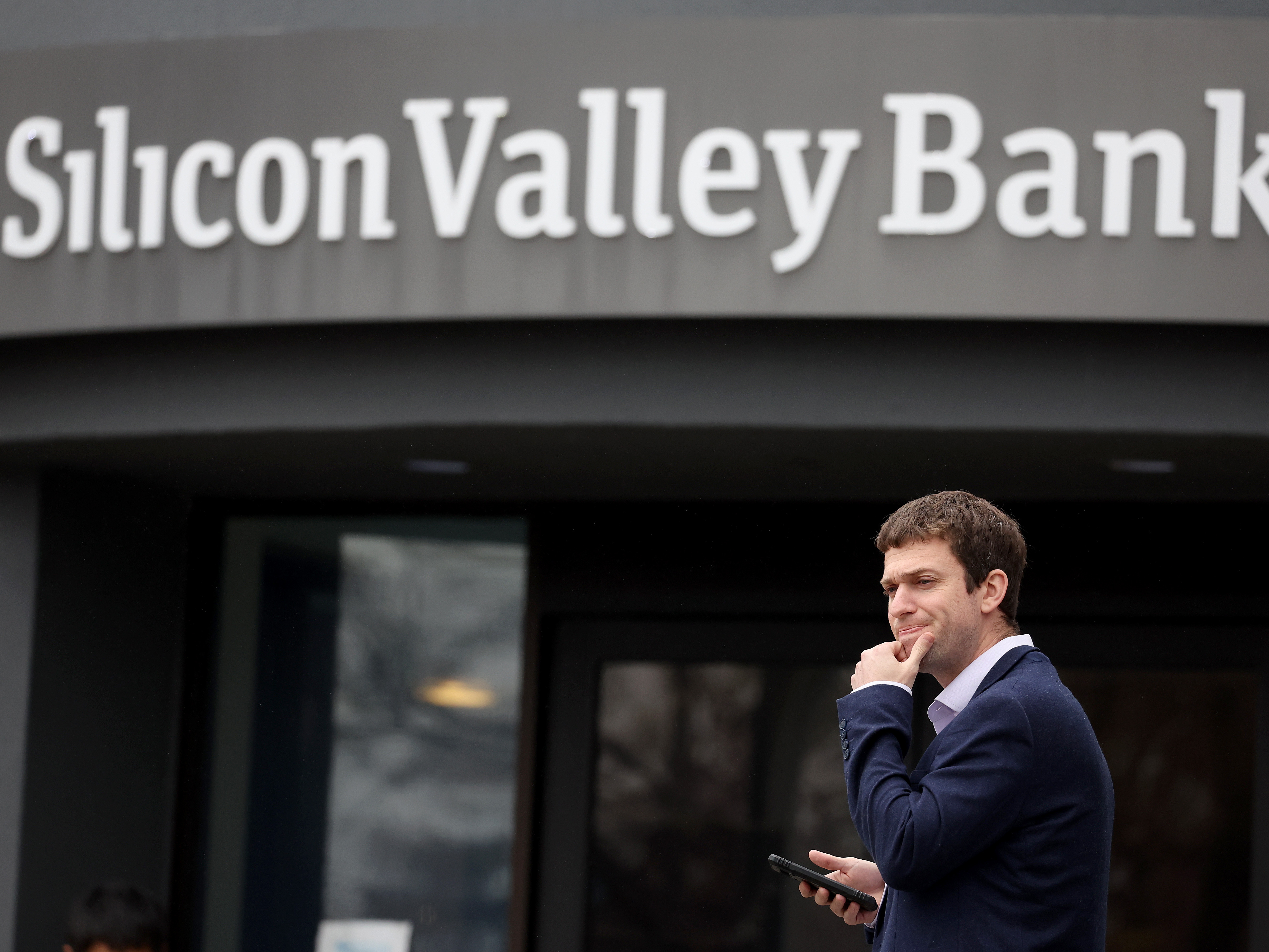 A customer stands outside of the shuttered Silicon Valley Bank headquarters in Santa Clara, Calif., on March 10, 2023. The lender was taken over federal regulators on Friday, marking one of the largest bank failures since the 2008 Global Financial Crisis. (Getty Images)