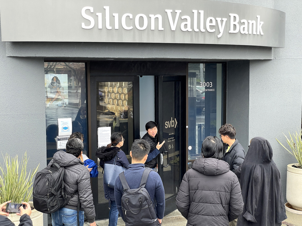 A worker tells people that the Silicon Valley Bank (SVB) headquarters in Santa Clara, Calif., is closed on March 10. Federal regulators took extraordinary measures on Sunday to backstop all deposits at SVB after the lender's spectacular collapse. (Getty Images)