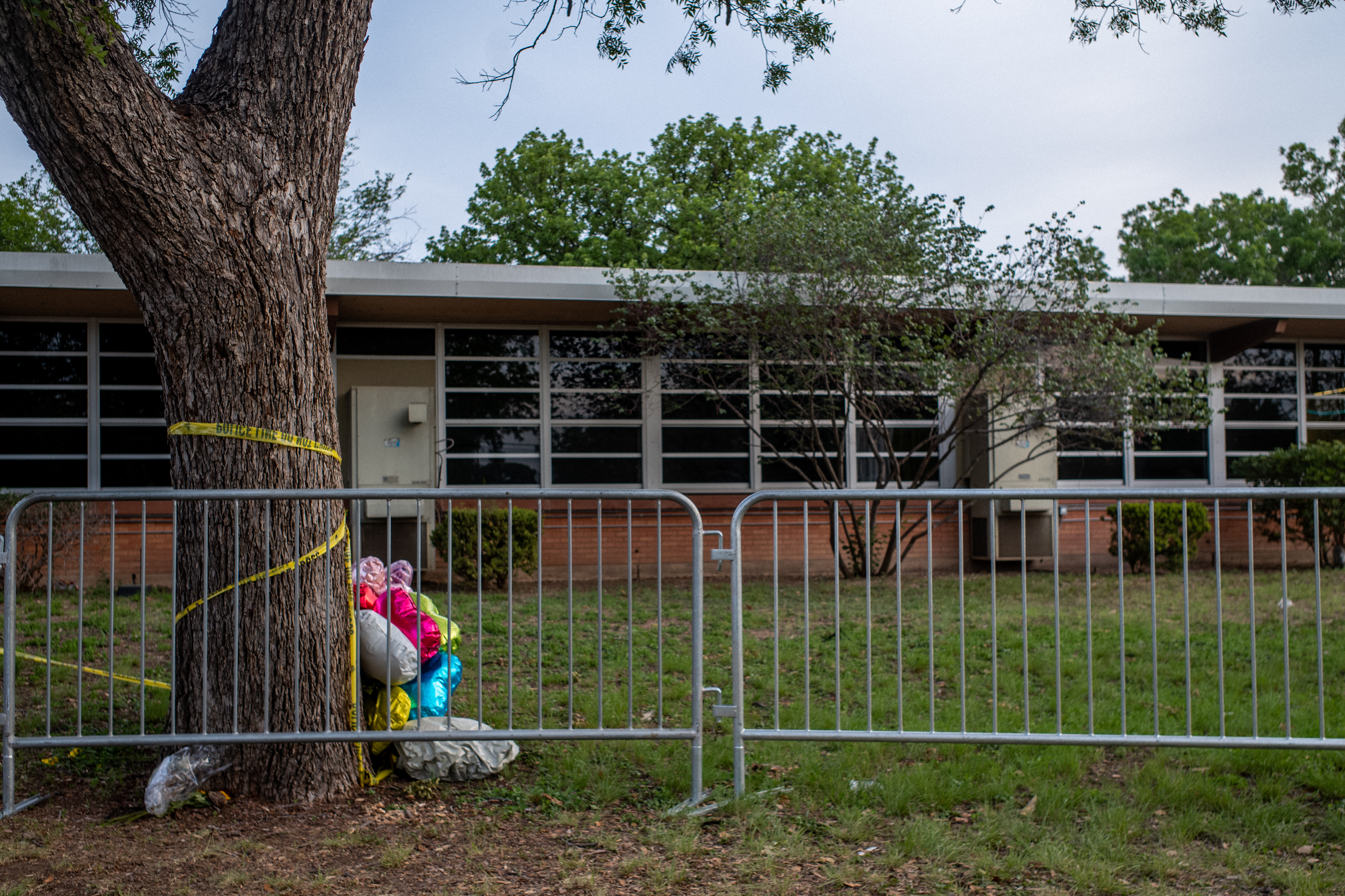 Balloons are seen wrapped around a tree in caution tape at Robb Elementary School on May 31, 2022 in Uvalde, Texas, a week after the school shooting. (Getty Images)