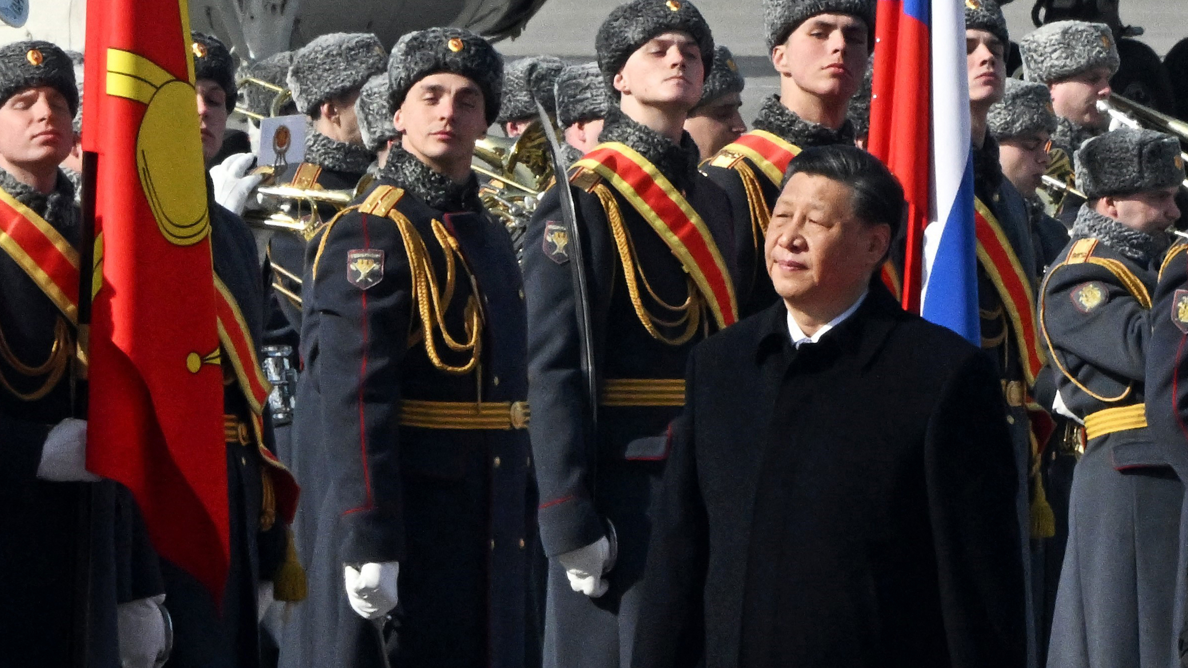 Chinese leader Xi Jinping walks past an honor guard during a welcoming ceremony at Moscow