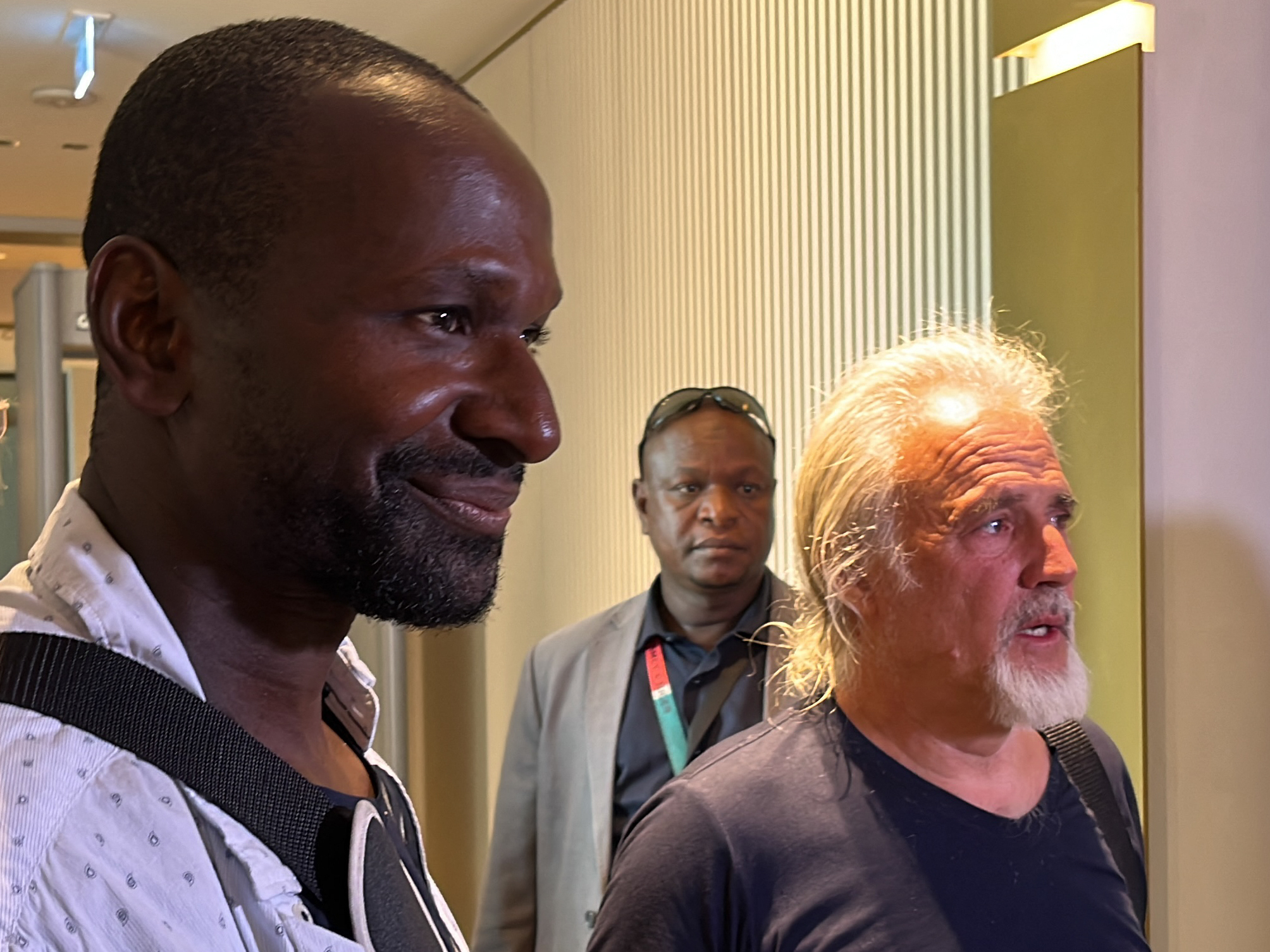 French journalist Olivier Dubois left, and Jeffery Woodke, right, are seen as they arrive at the Diori Hamani International Airport in Niamey on Monday. (AFP via Getty Images)