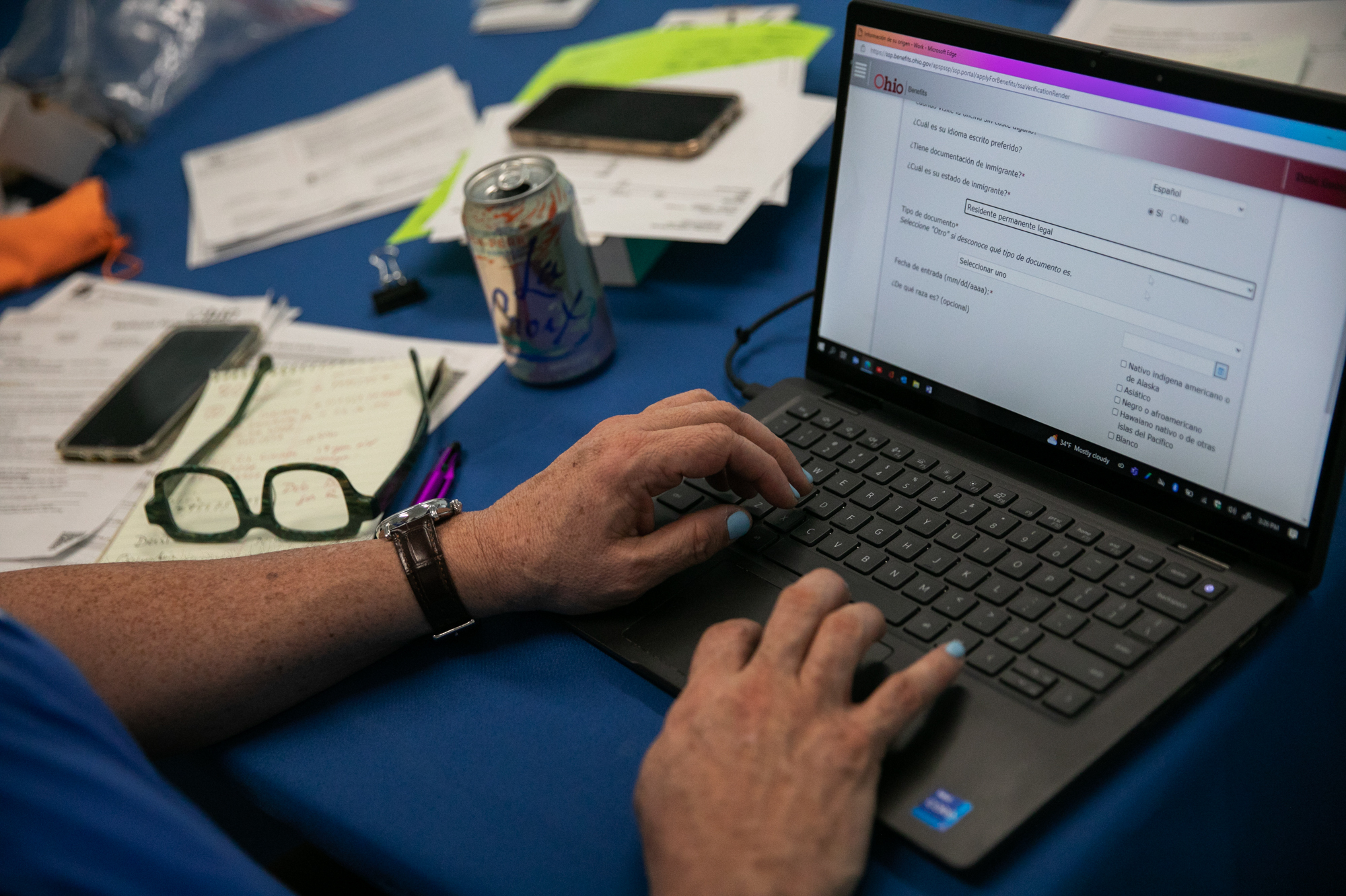 Samuel Camacho, a health insurance navigator with the Universal Health Care Action Network of Ohio, assists people in enrolling for or renewing Medicaid. A pandemic-era rule that prevented states from dropping people from Medicaid expires on March 31. (Maddie McGarvey for NPR)