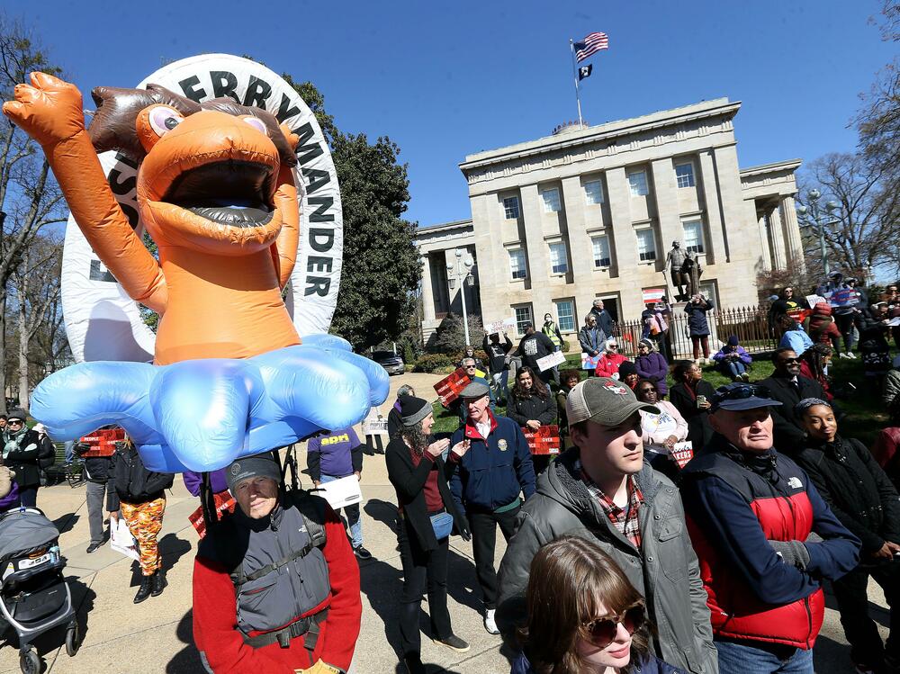 Demonstrators gather outside the North Carolina State Capitol in Raleigh, N.C., with a "FLUSH GERRYMANDER" inflatable on the day the state's highest court held a rehearing for the redistricting case known nationally as <em>Moore v. Harper</em>. (ZUMA Press/Alamy)