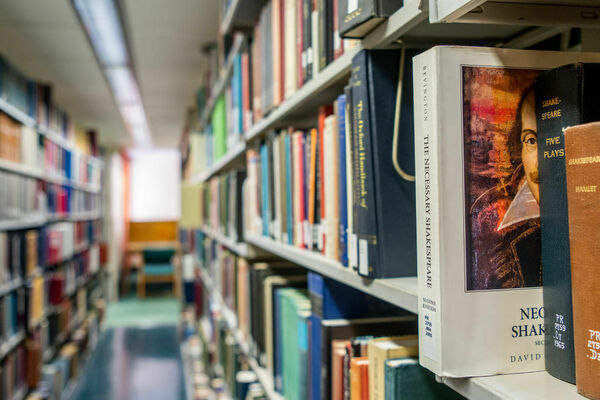 Books line the shelves at the Rice University Library in April 2022 in Houston.