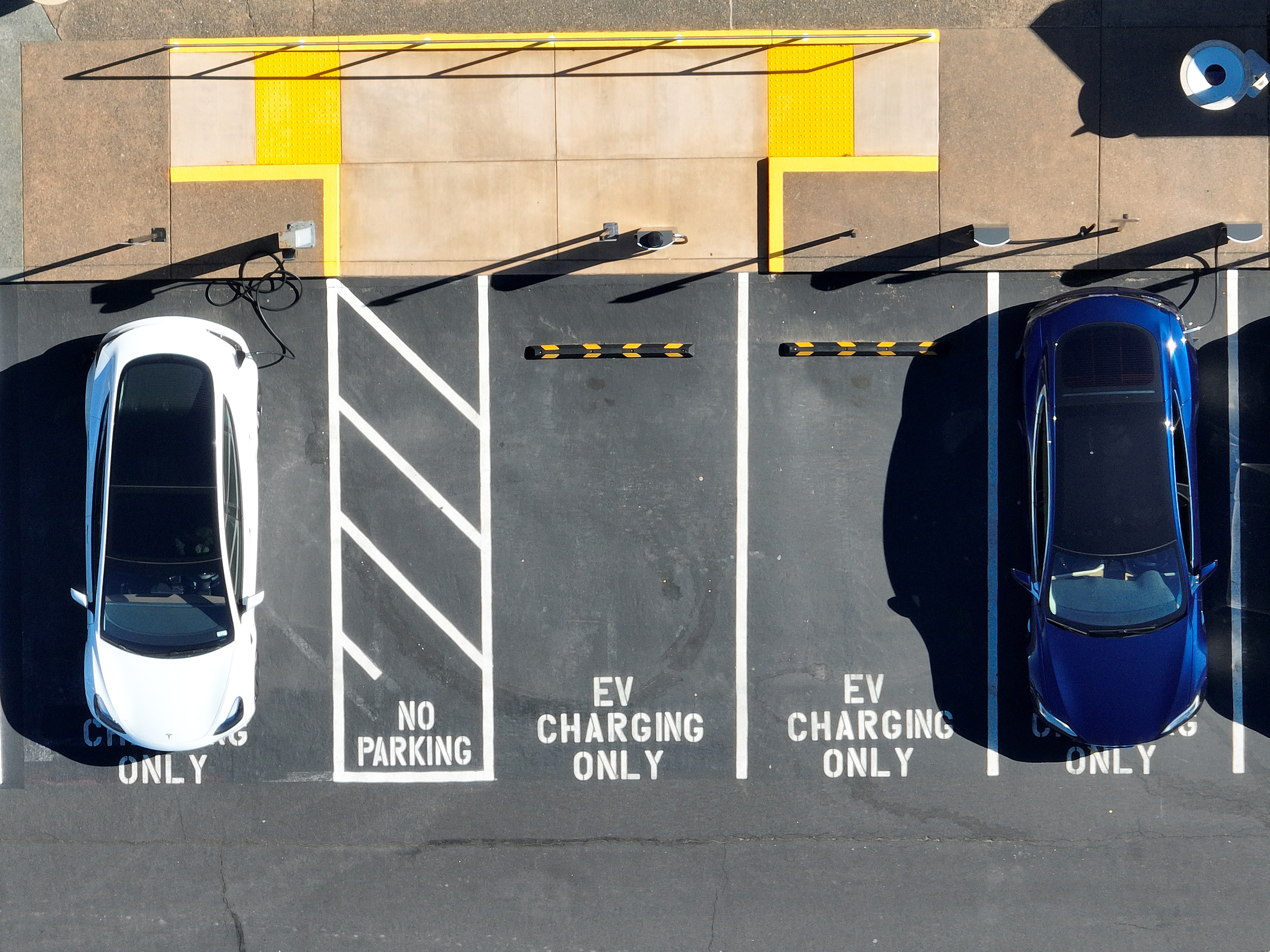 In an aerial view, Tesla cars recharge at a Tesla charger station in Corte Madera, Calif., on Feb. 15, 2023. The Biden administration wants to boost sales of electric cars, but it also wants to incentivize U.S.-based production. (Getty Images)
