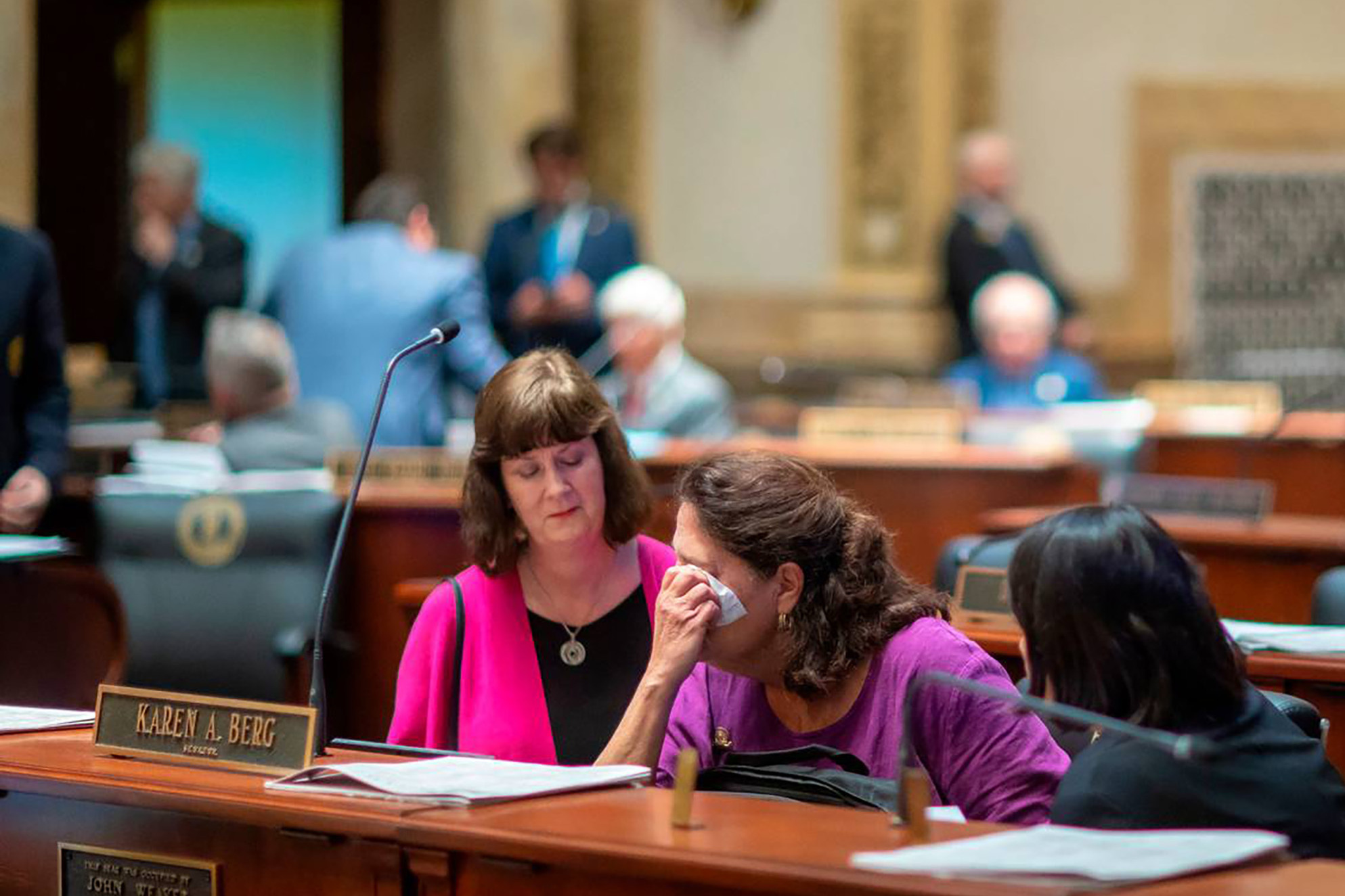 Kentucky state Sen. Karen Berg, who lost her transgender son to suicide in 2022, is consoled by former state legislator Patti Minter, left, and Rep. Tina Bojanowski after SB 150 passed the Senate on Feb. 16, 2023, in Frankfort, Ky. (Lexington Herald-Leader/TNS via Getty Images)