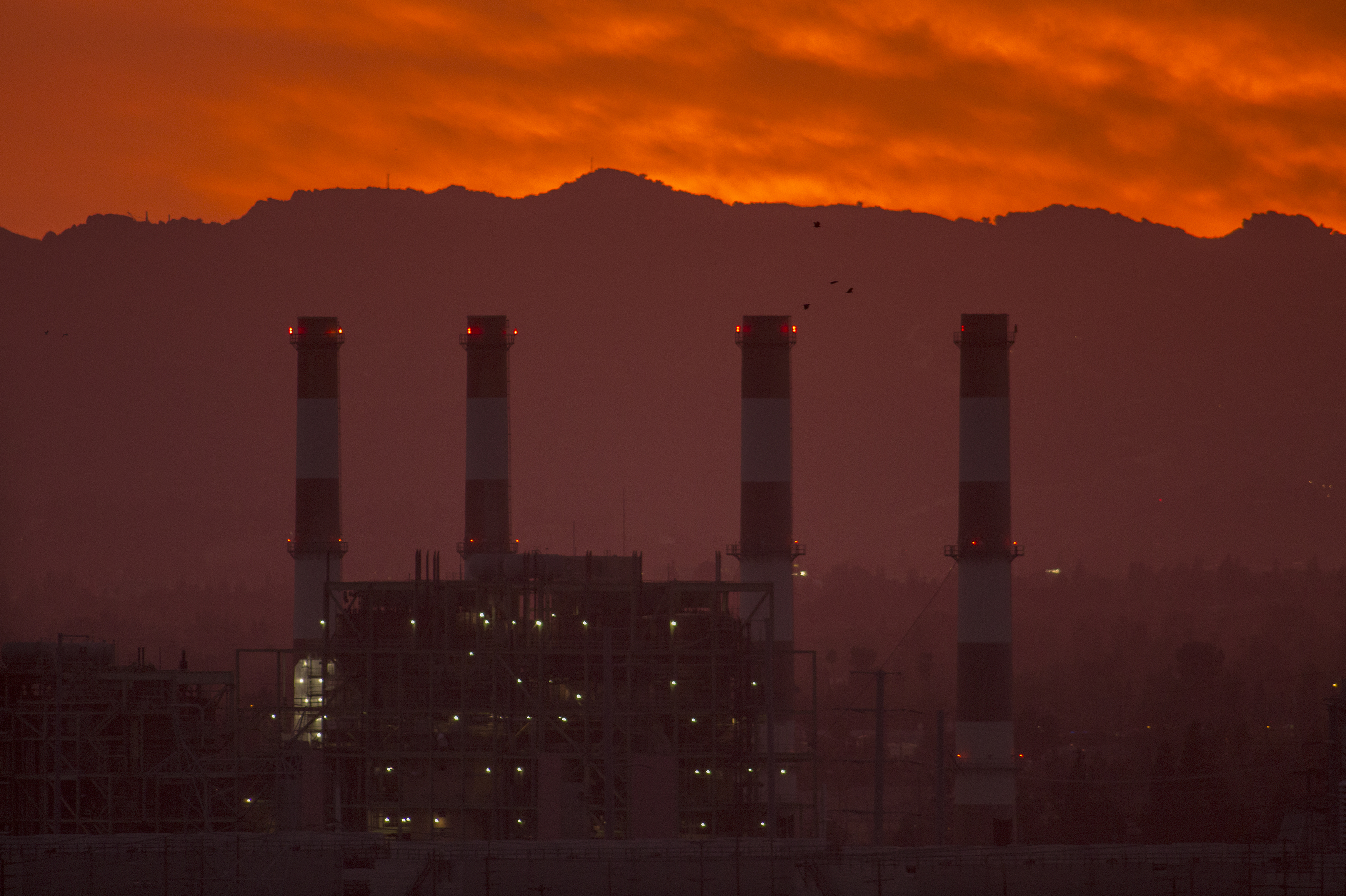 To avoid some of the worst impacts of climate change, greenhouse gas emissions need to be eliminated or offset by midcentury, according to the United Nations. To get there, activist investors say banks and insurance companies need to account for the emissions they contribute to by underwriting and investing in fossil fuel infrastructure like this natural gas plant in California. (Getty Images)