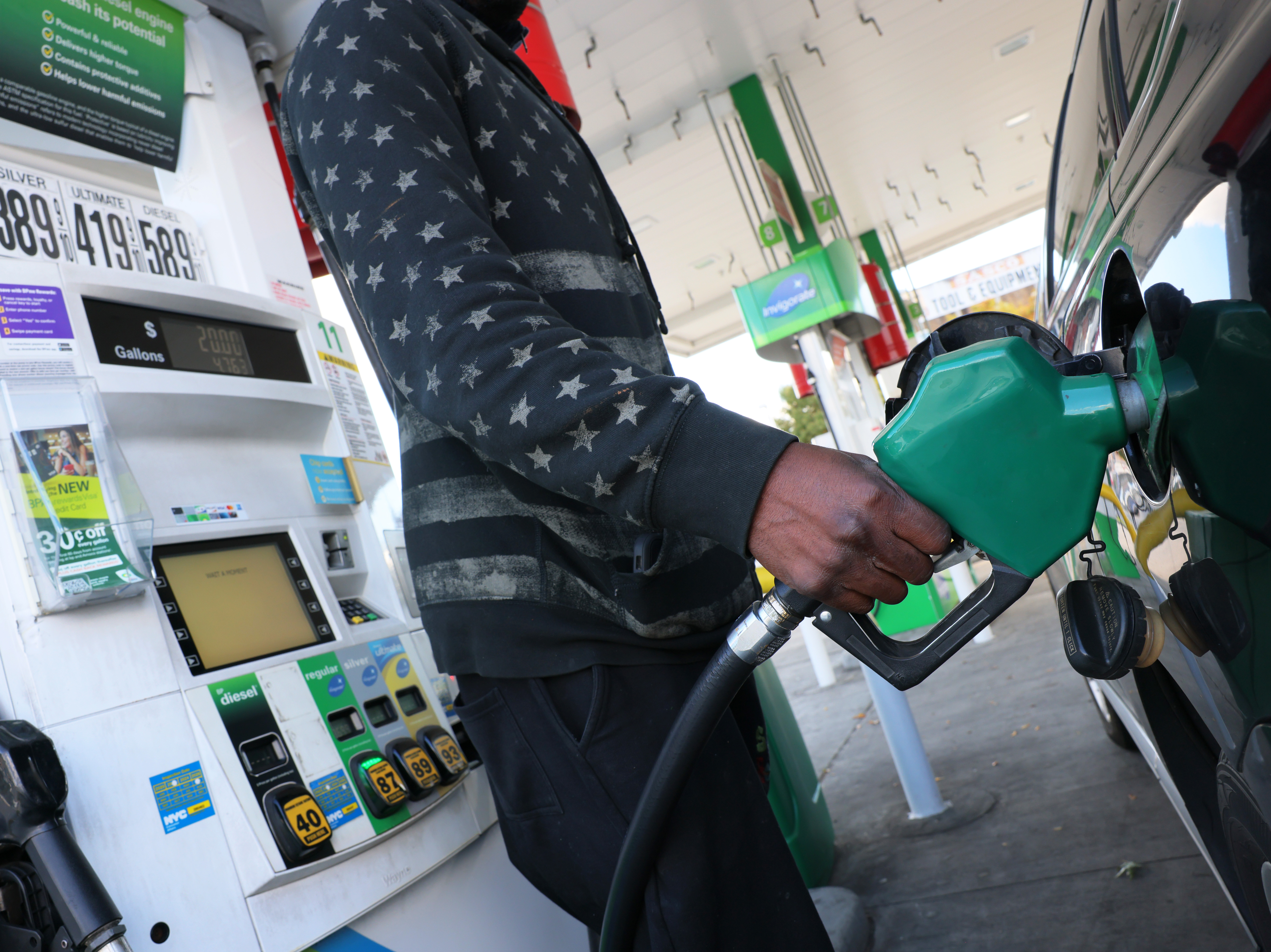 A person prepares to pump gas at a BP gas station in Brooklyn, New York City, on Oct. 19, 2022. Americans could save between $580 billion and $1.1 trillion on gasoline under the EPA's proposed auto emission regulations, according to the agency. (Getty Images)