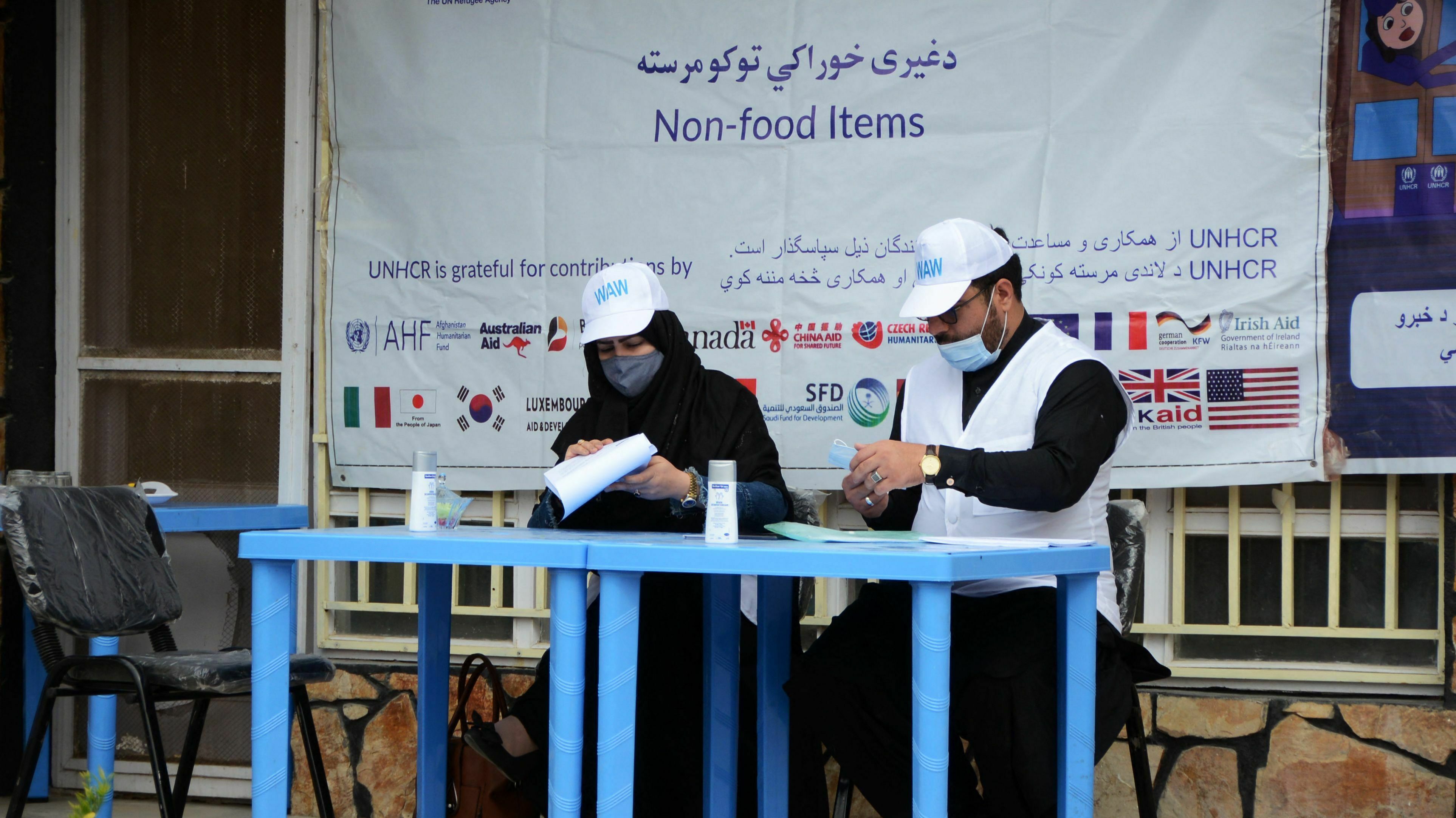 United Nations High Commissioner for Refugees workers prepare to distribute non-food items to women at UNHCR office in Kandahar on March 8, 2022. The Taliban has demanded that Afghan women no longer work for the UN or NGOs.