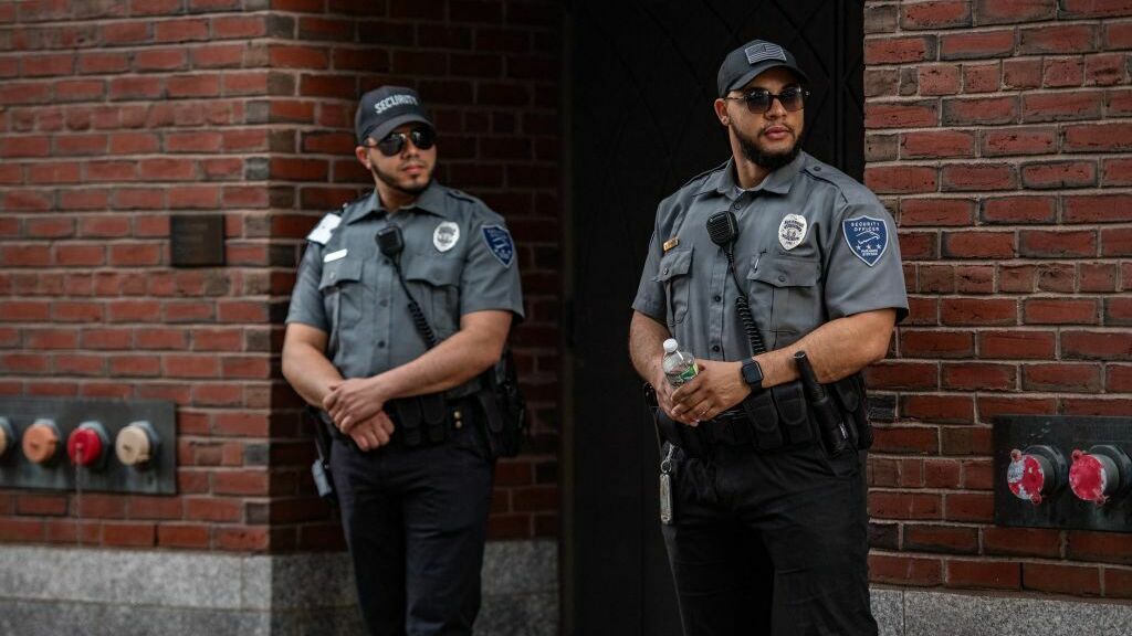 Security guards stand outside the entrance to the John Joseph Moakley United States Courthouse in Boston on Friday. Jack Teixeira, 21, an employee of the U.S. Air Force National Guard, appeared at the federal court Friday. (AFP via Getty Images)