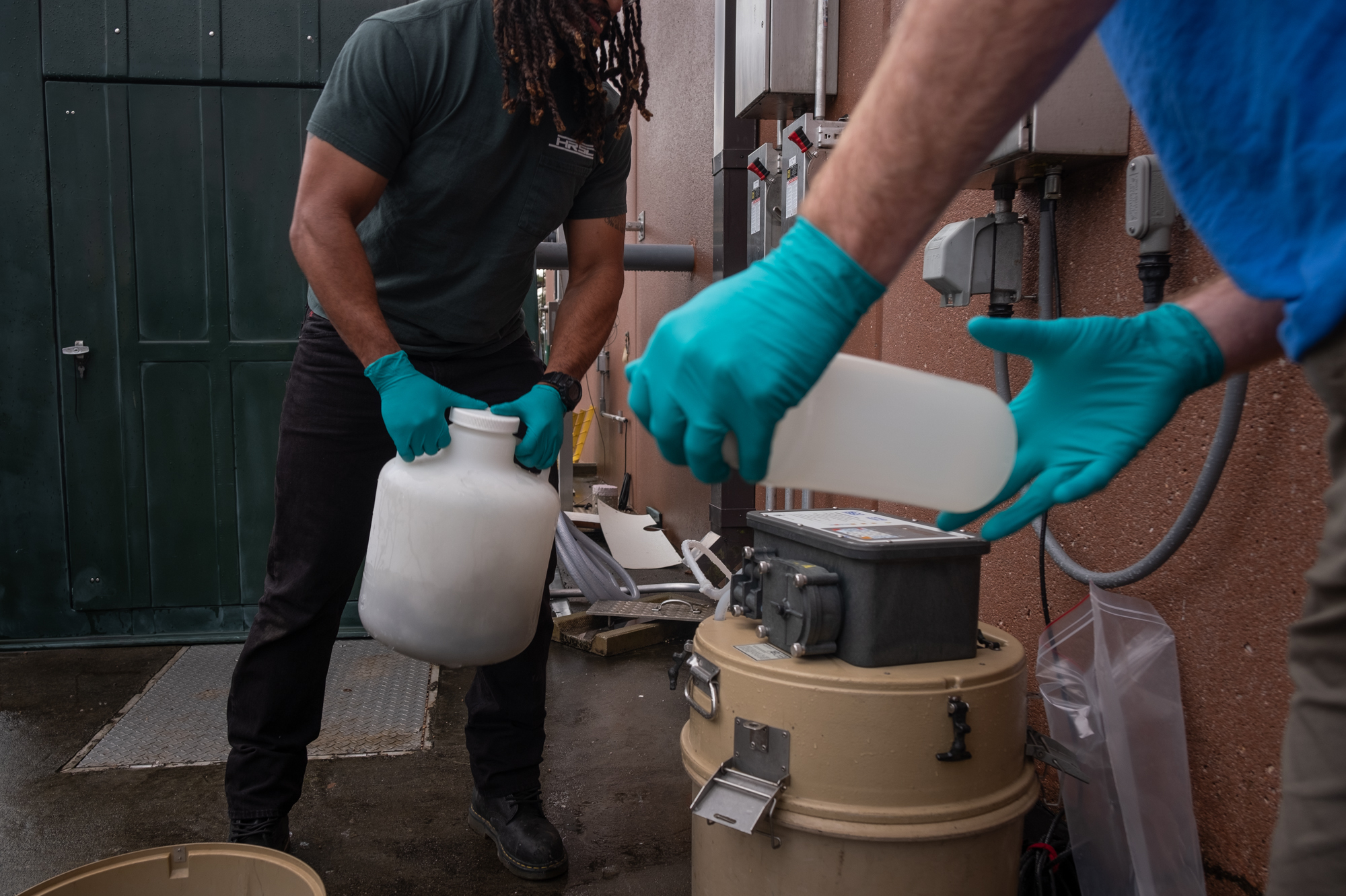 Tracking health threats, one sewage sample at a time 2 Marcos Davila-Banrey and Jon Nelson prepare to capture a wastewater sample for the Hampton Roads Sanitation District COVID surveillance program.