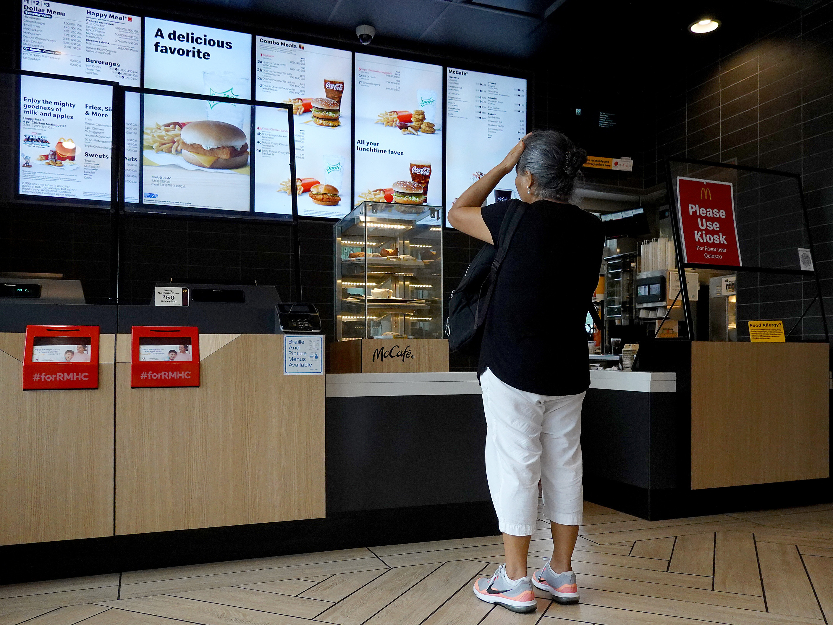 A customer waits to order food at a Miami McDonald's on July 26, 2022. The CEO of McDonald's expects the U.S. to experience a mild recession and says customers have grown more reluctant to splurge on or supersize their orders. (Getty Images)